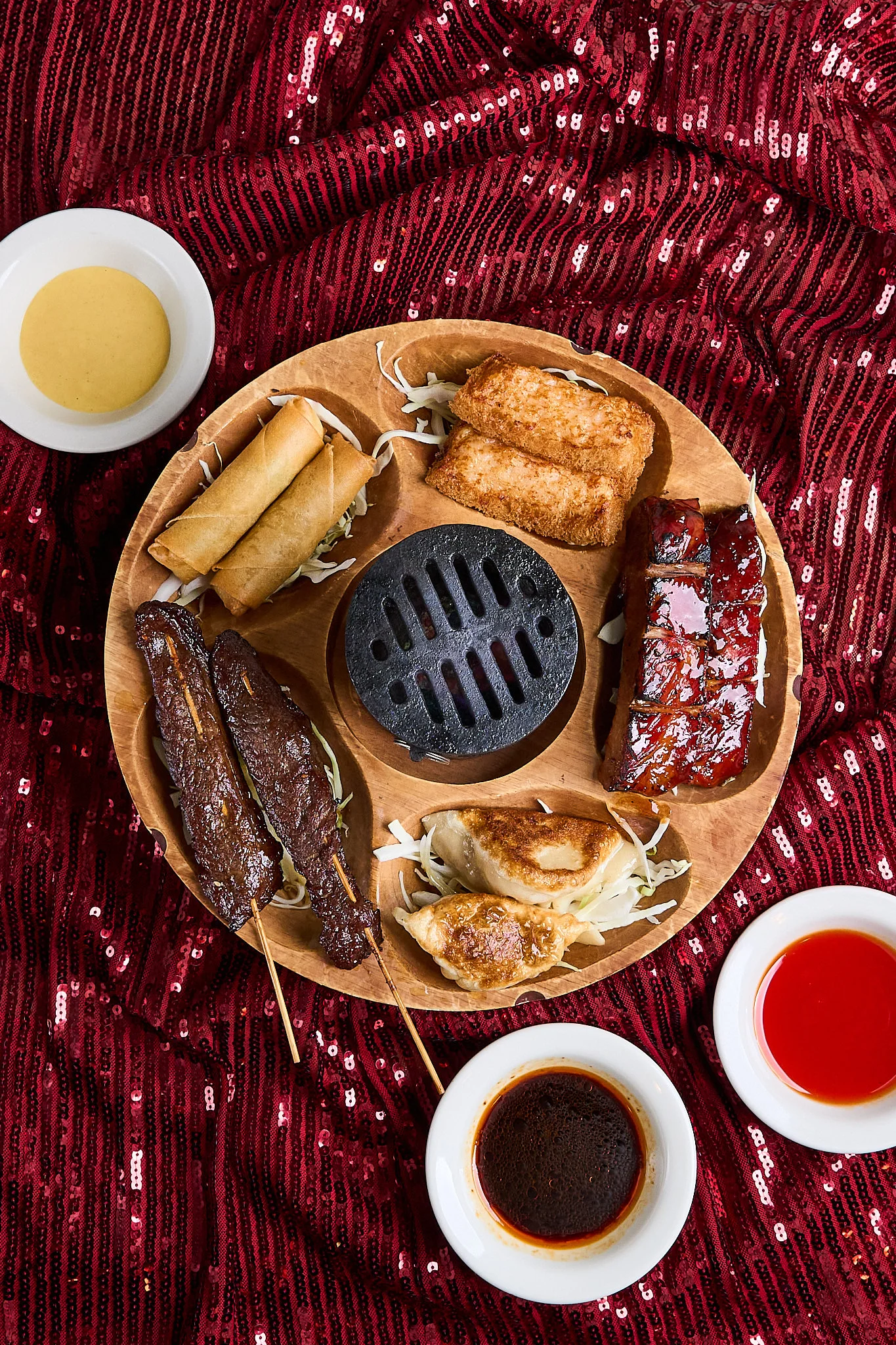 Assorted Asian barbecue platter with skewers and dumplings