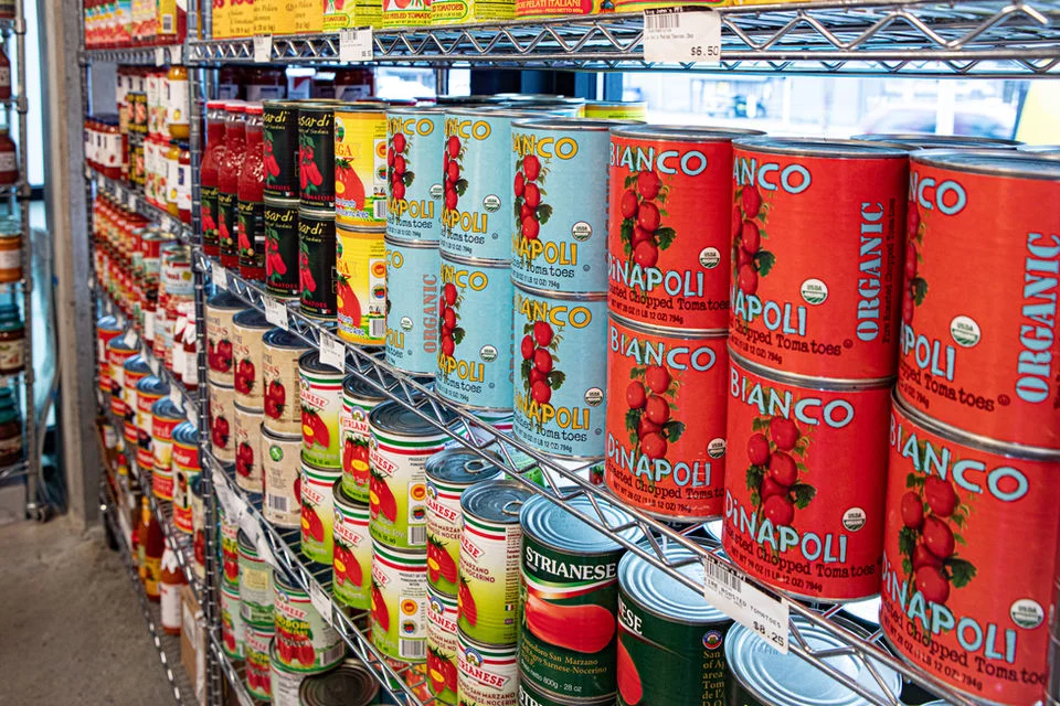 Variety of canned tomatoes on store shelves