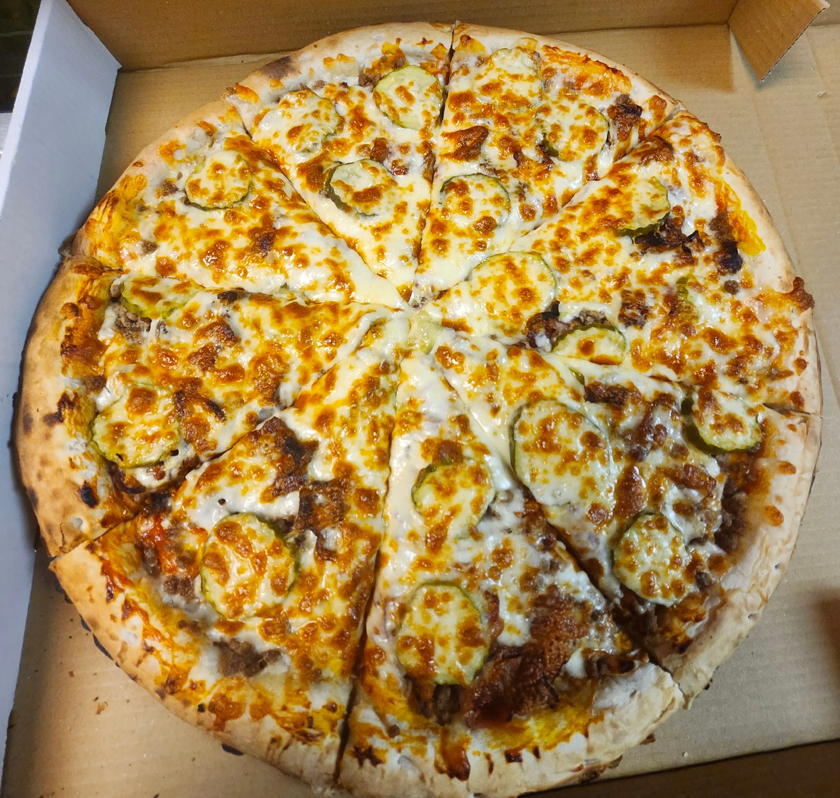 Delicious Chicago-style pizza topped with cheese and pickles