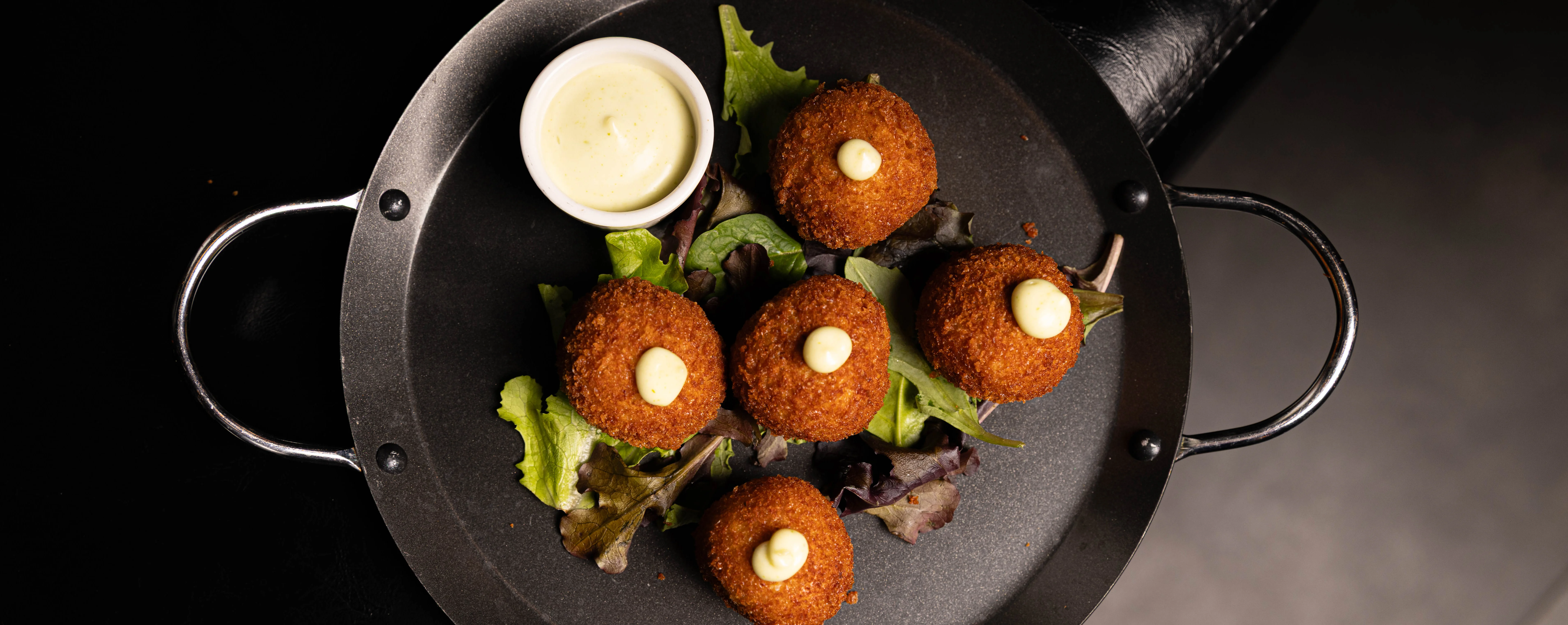Crispy falafel balls served with dipping sauce