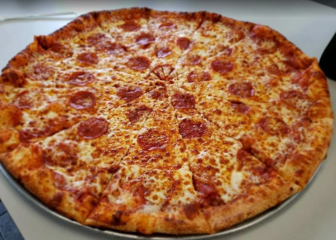 Large pepperoni pizza on a silver platter