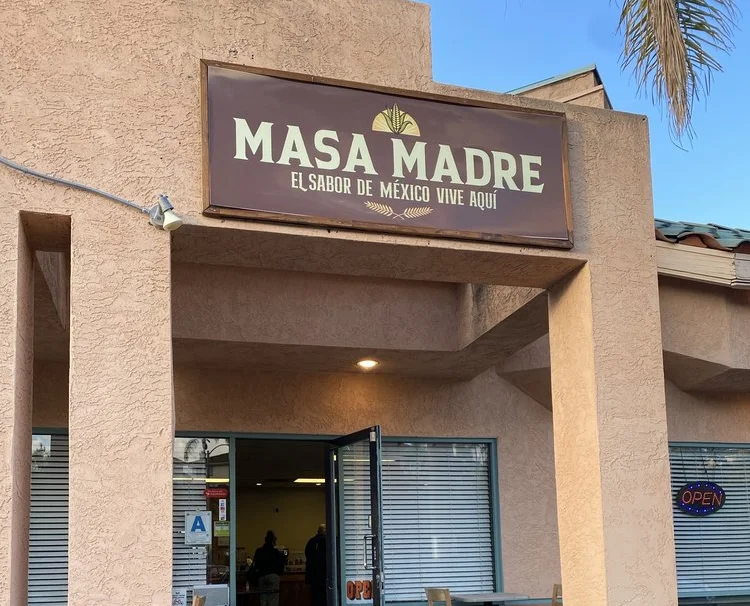 Exterior view of Masa Madre Mexican restaurant with open door