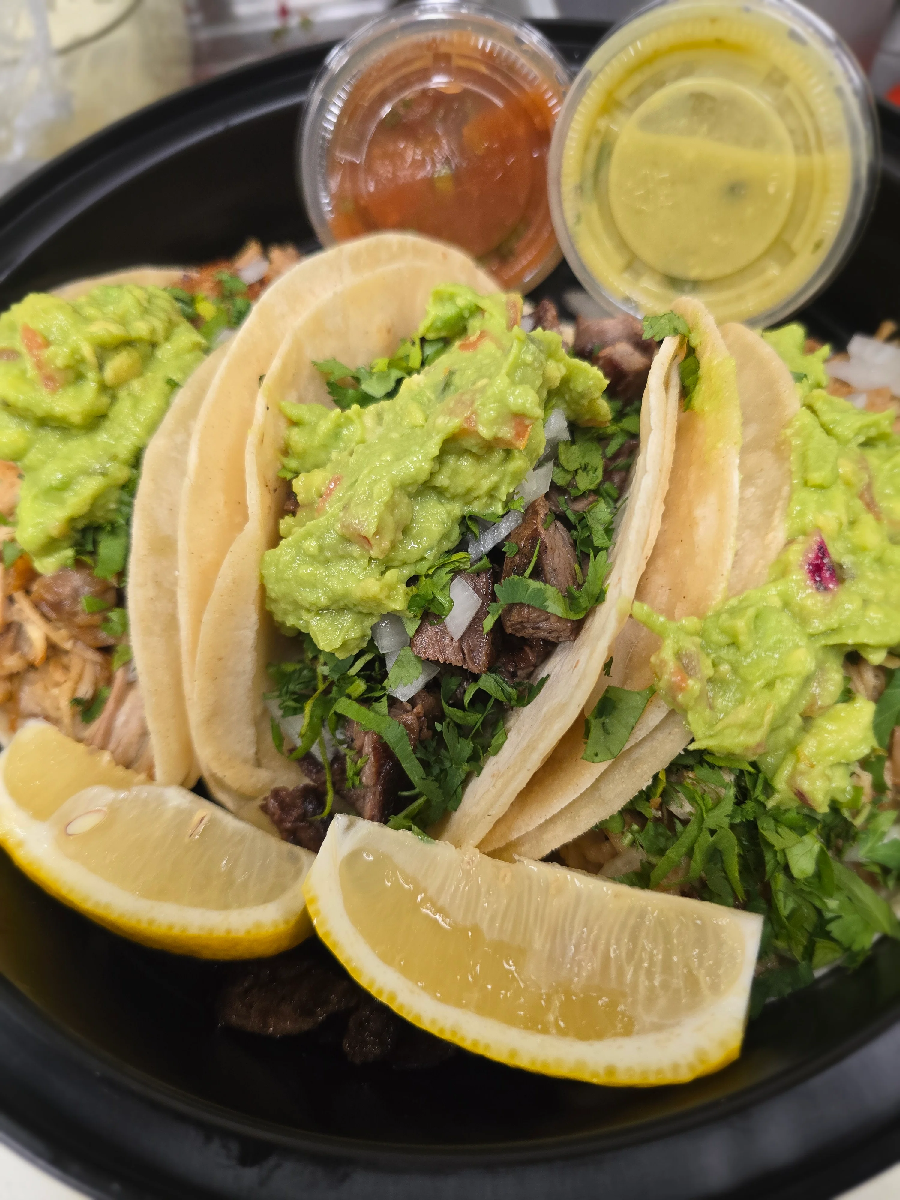 Authentic Mexican street tacos with guacamole and salsa