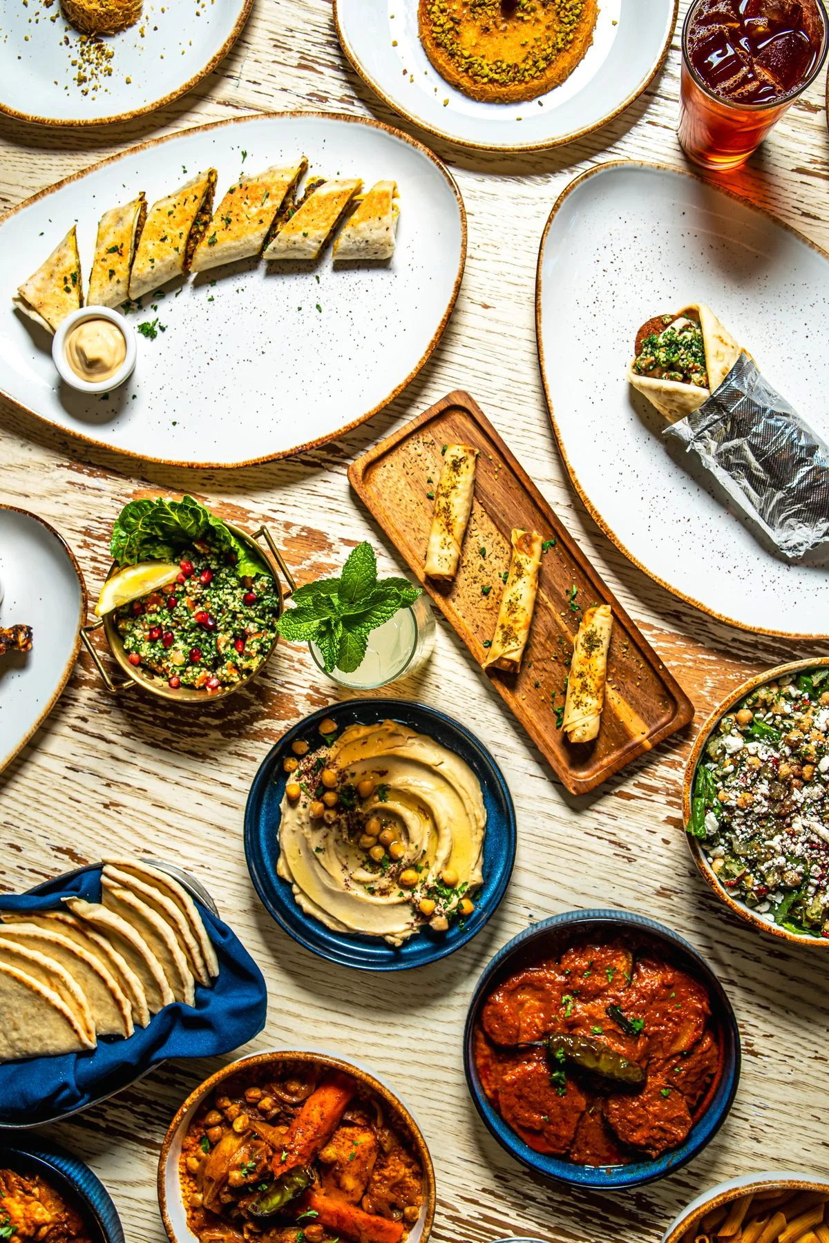 Abundant Middle Eastern mezze spread with hummus, pita, tabbouleh, and savory dishes