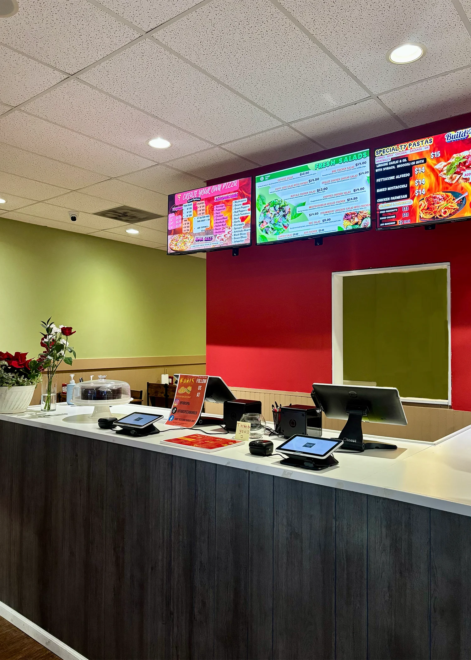 Modern restaurant counter with digital menu displays