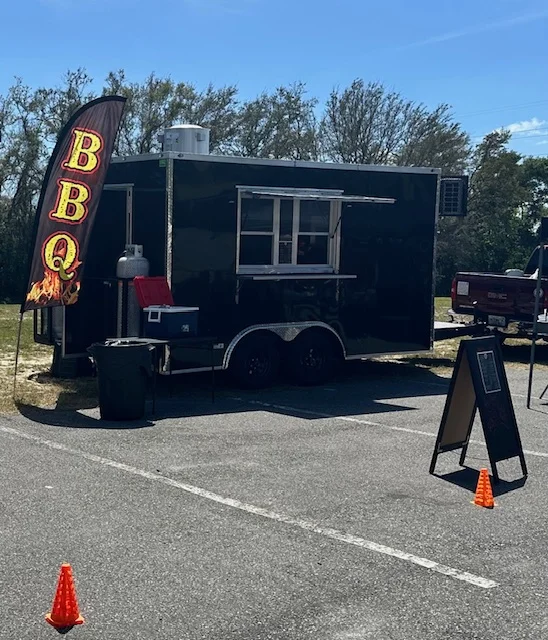 Mobile BBQ food truck with vibrant signage