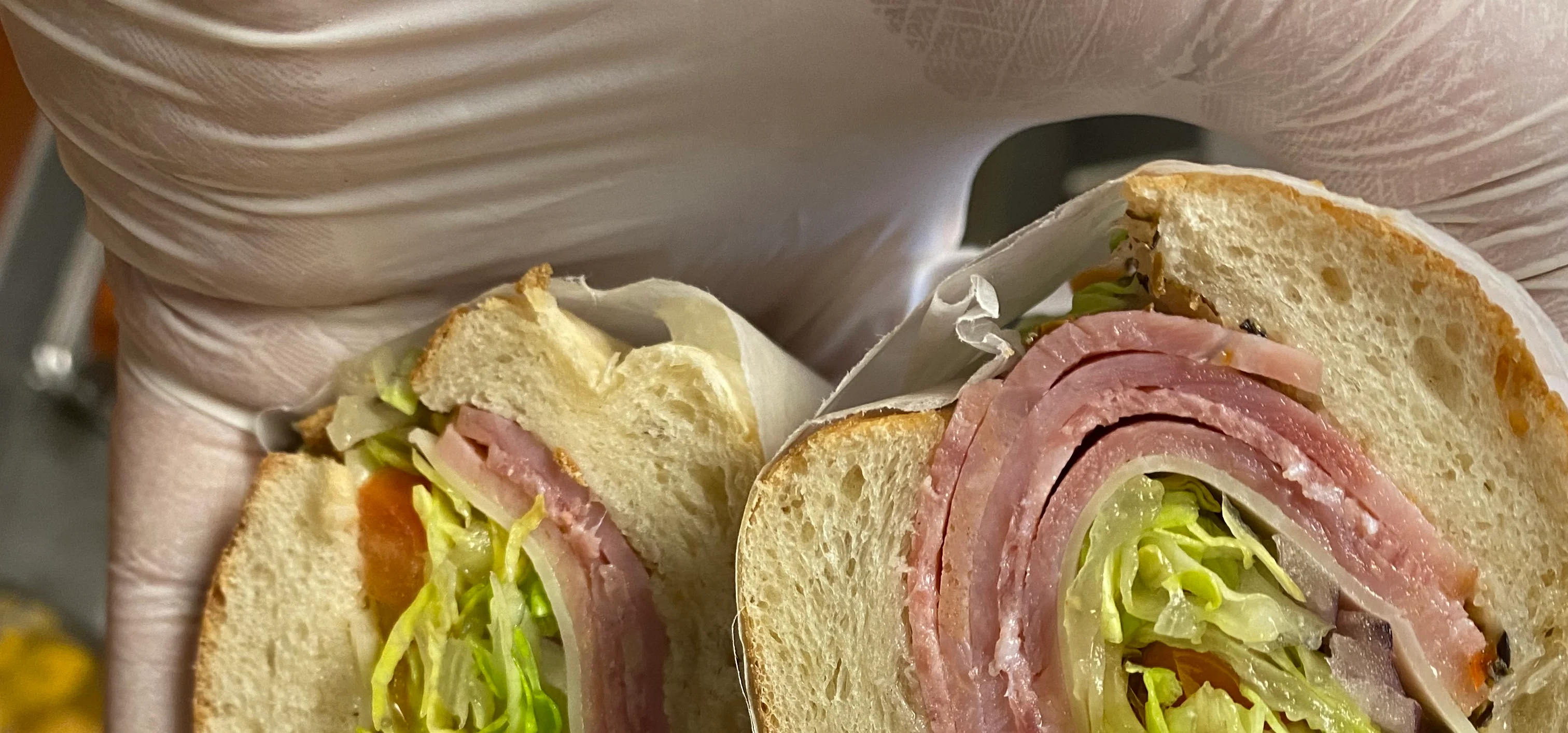Italian sub sandwich with layers of meats and fresh vegetables