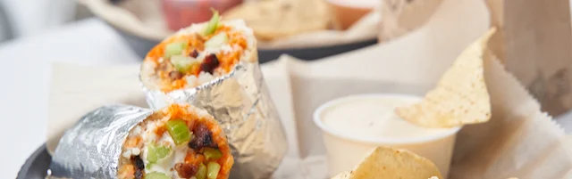 Delicious burritos served with tortilla chips and dipping sauce