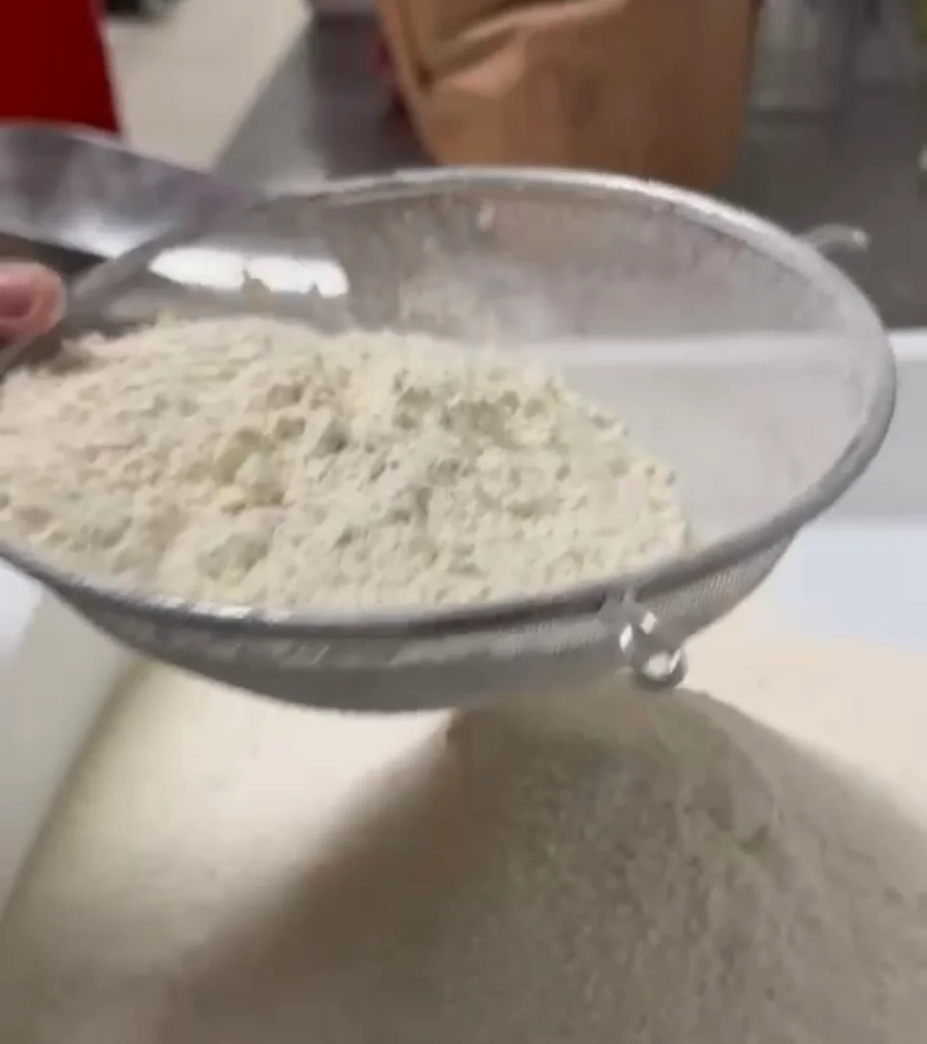 Sifting flour in a professional kitchen for baking