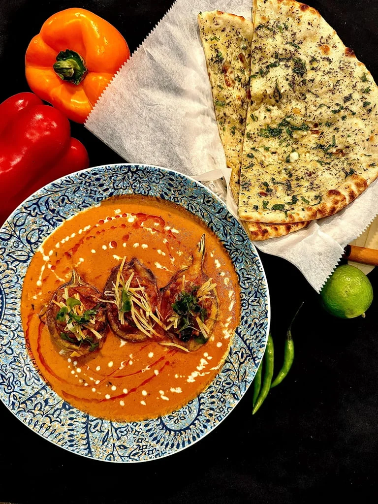 Rich Indian butter chicken with naan bread