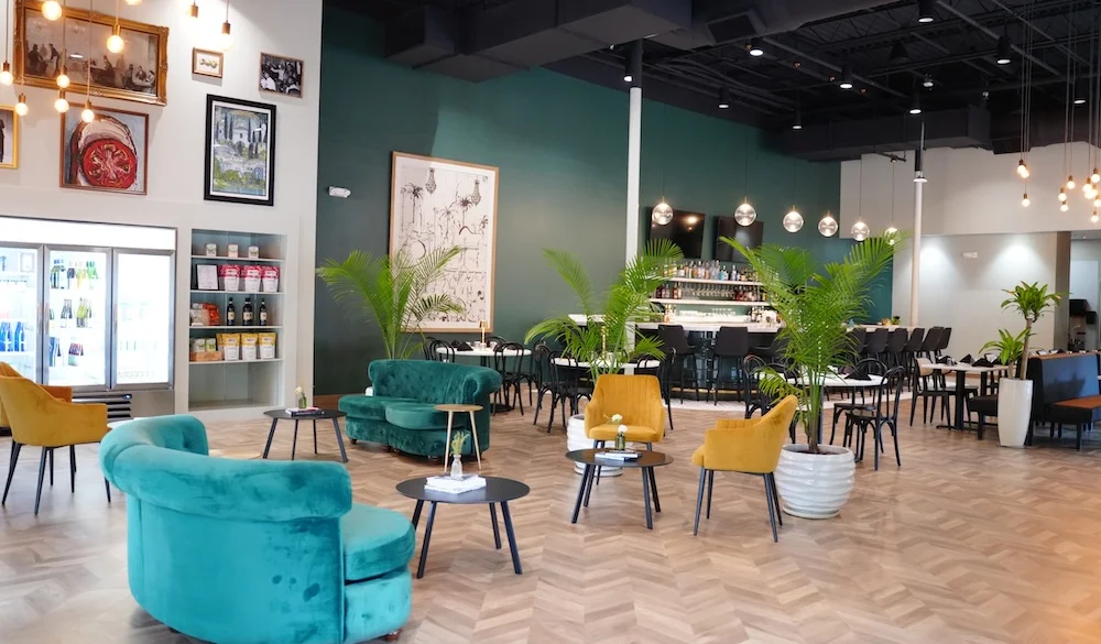 Modern restaurant interior with stylish seating and greenery
