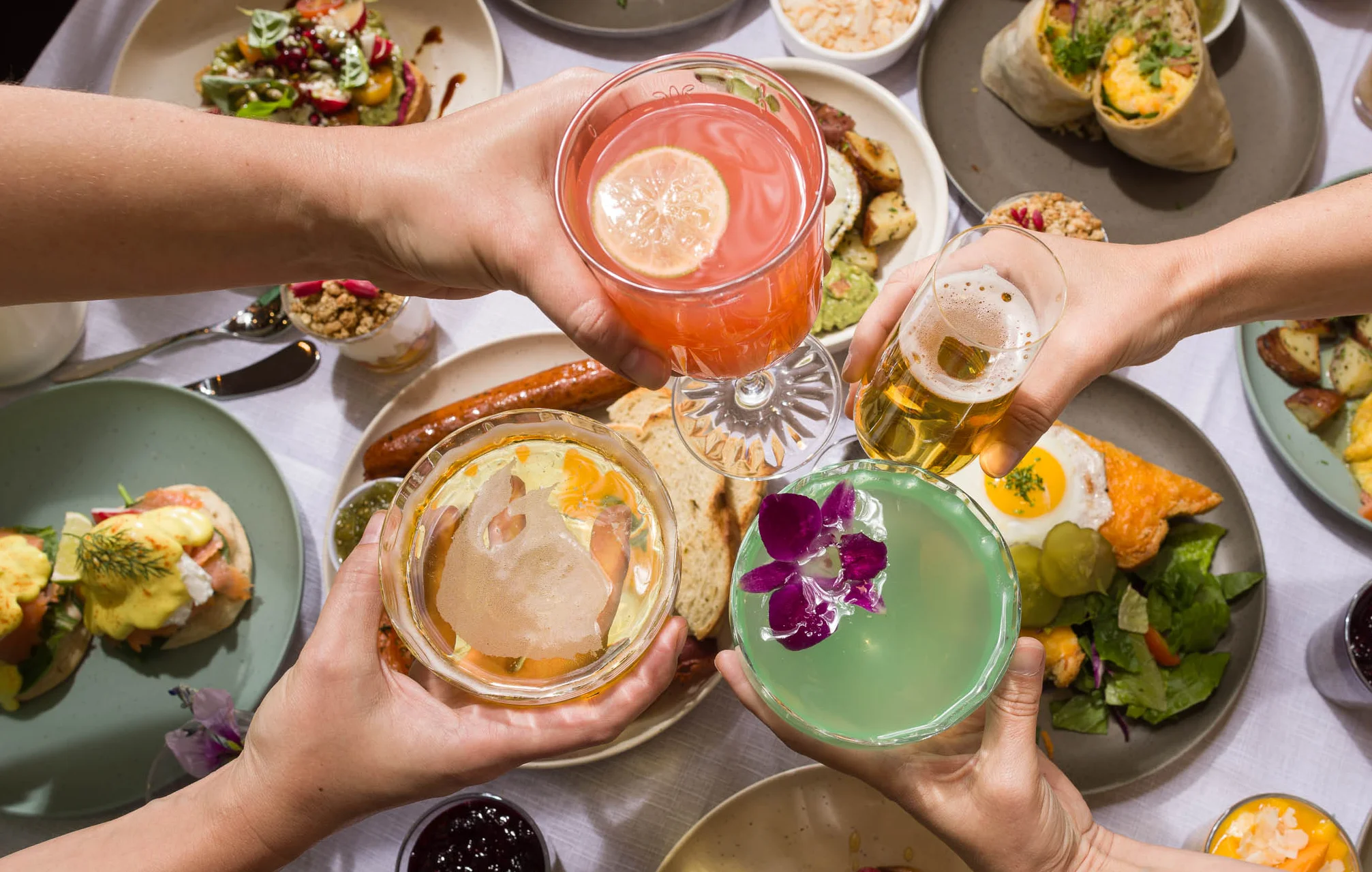 Brunch spread with cocktails and diverse dishes on a table