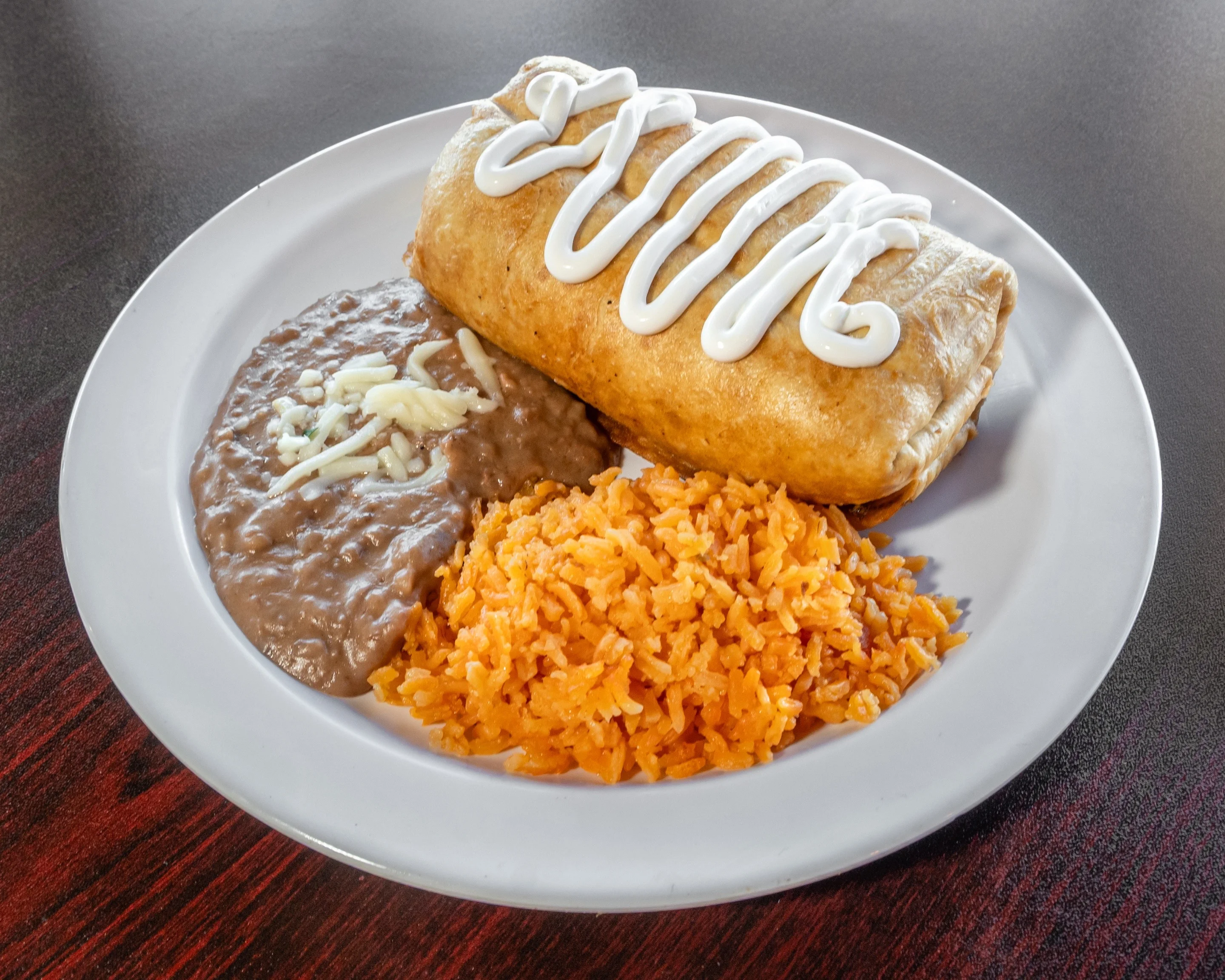 Delicious baby chimichanga served with toppings and garnishes.