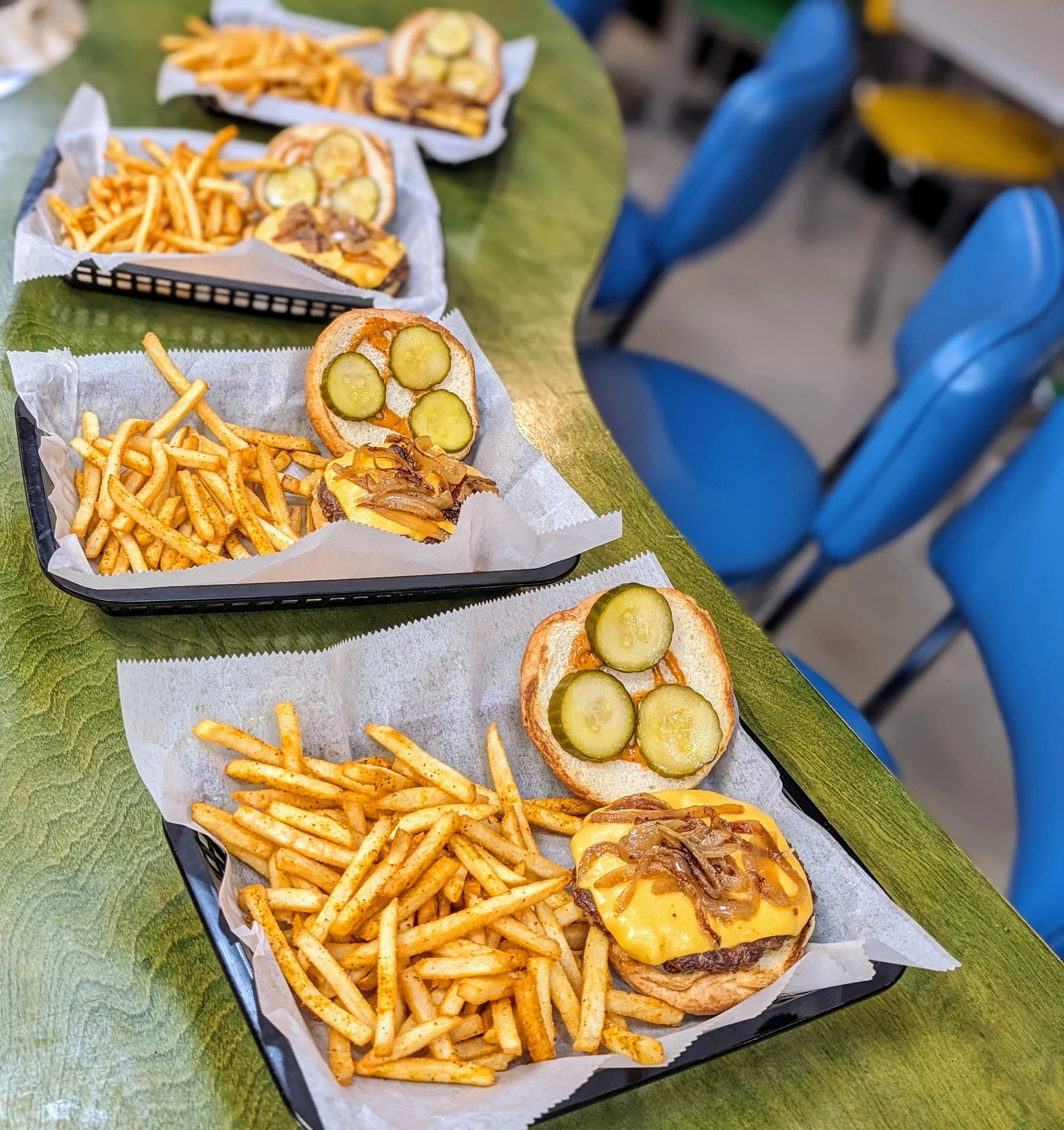 Classic American cheeseburgers with fries served in a casual setting