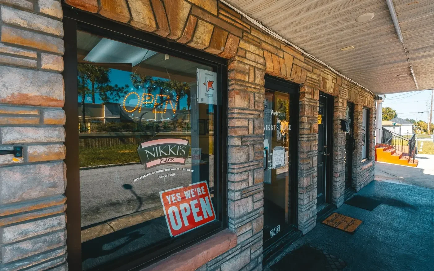 Exterior view of Nikki's Place restaurant with open sign