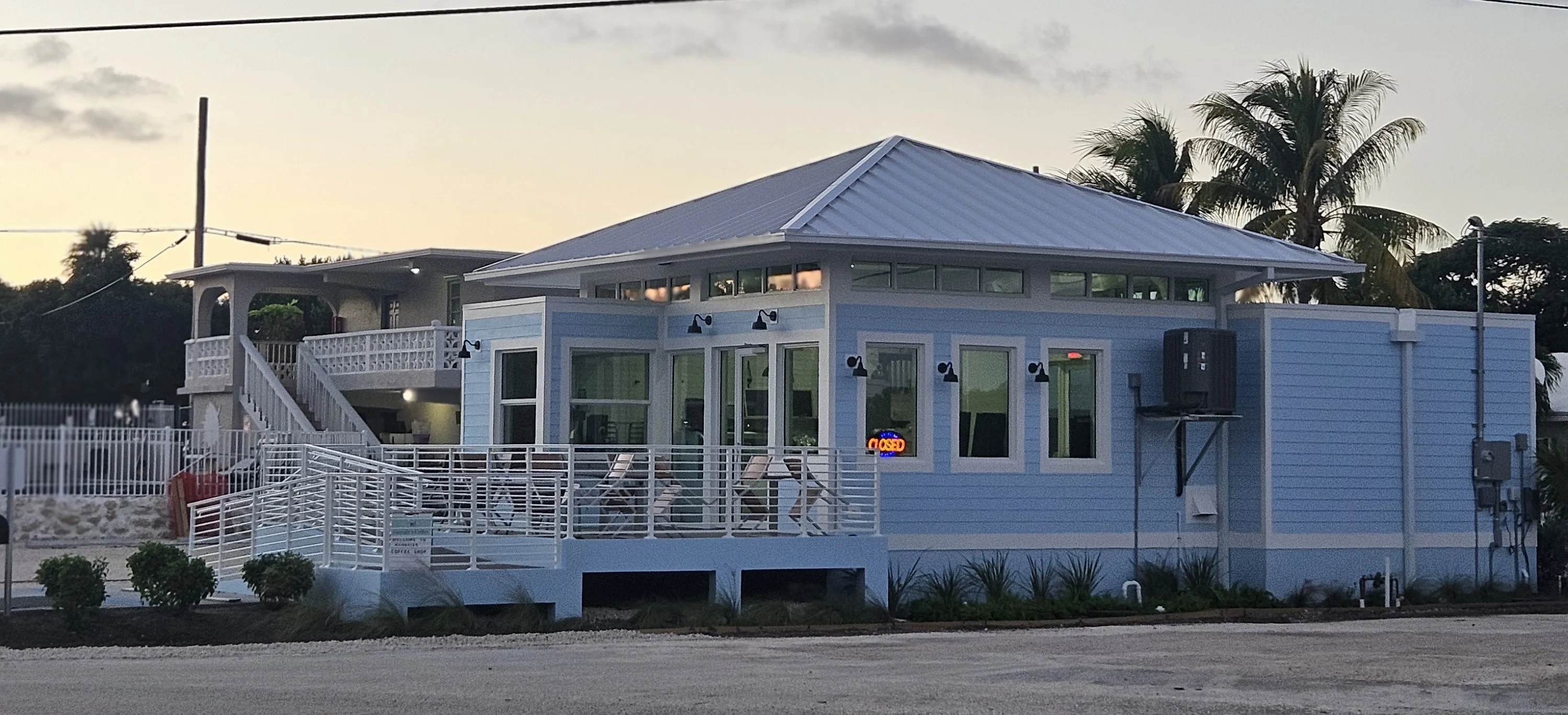 Charming coastal restaurant exterior at sunset