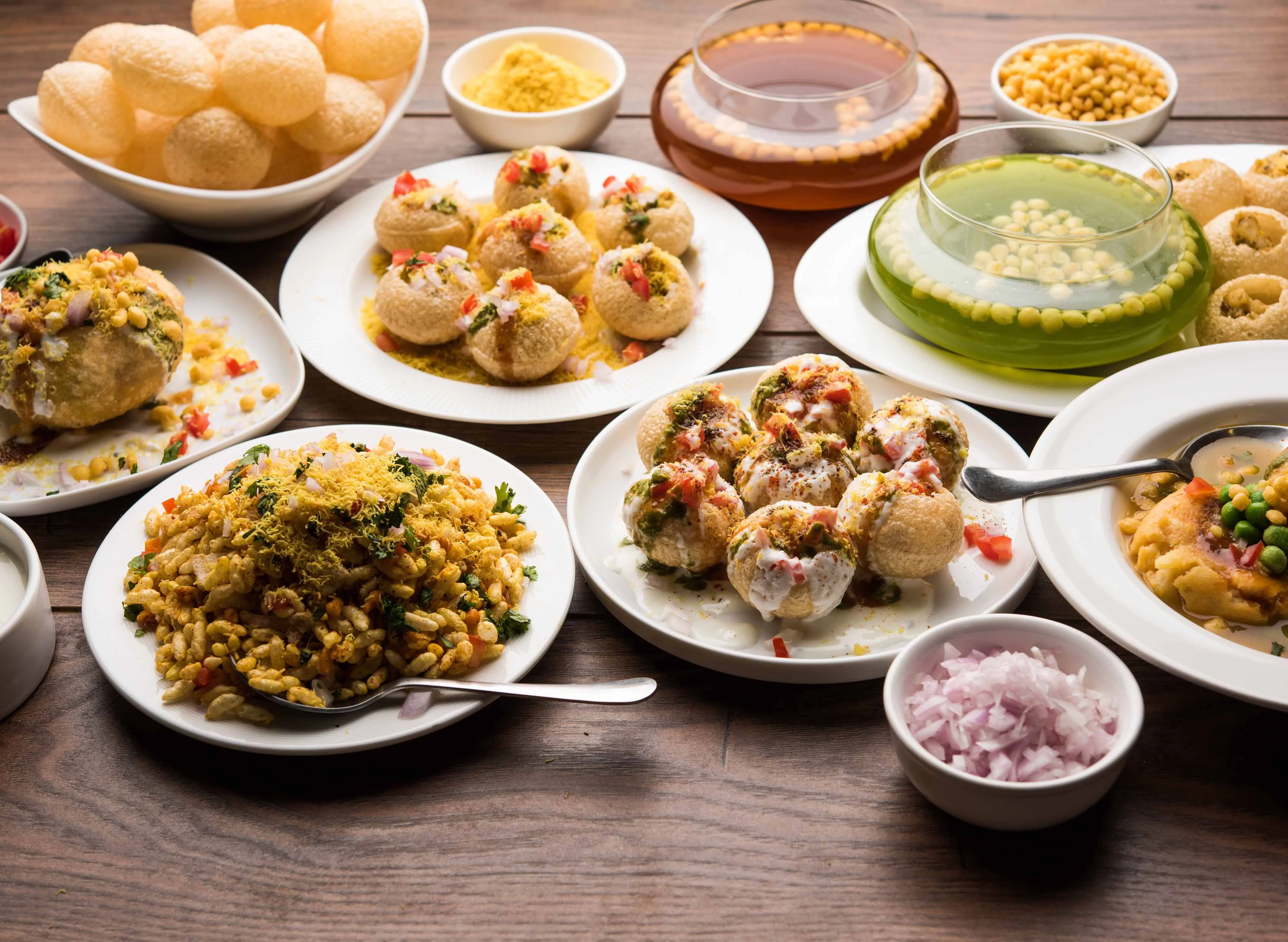 Assorted Indian street snacks including pani puri and bhel puri