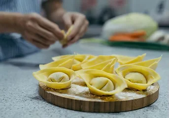 Homemade Chinese dumplings being prepared on a wooden board