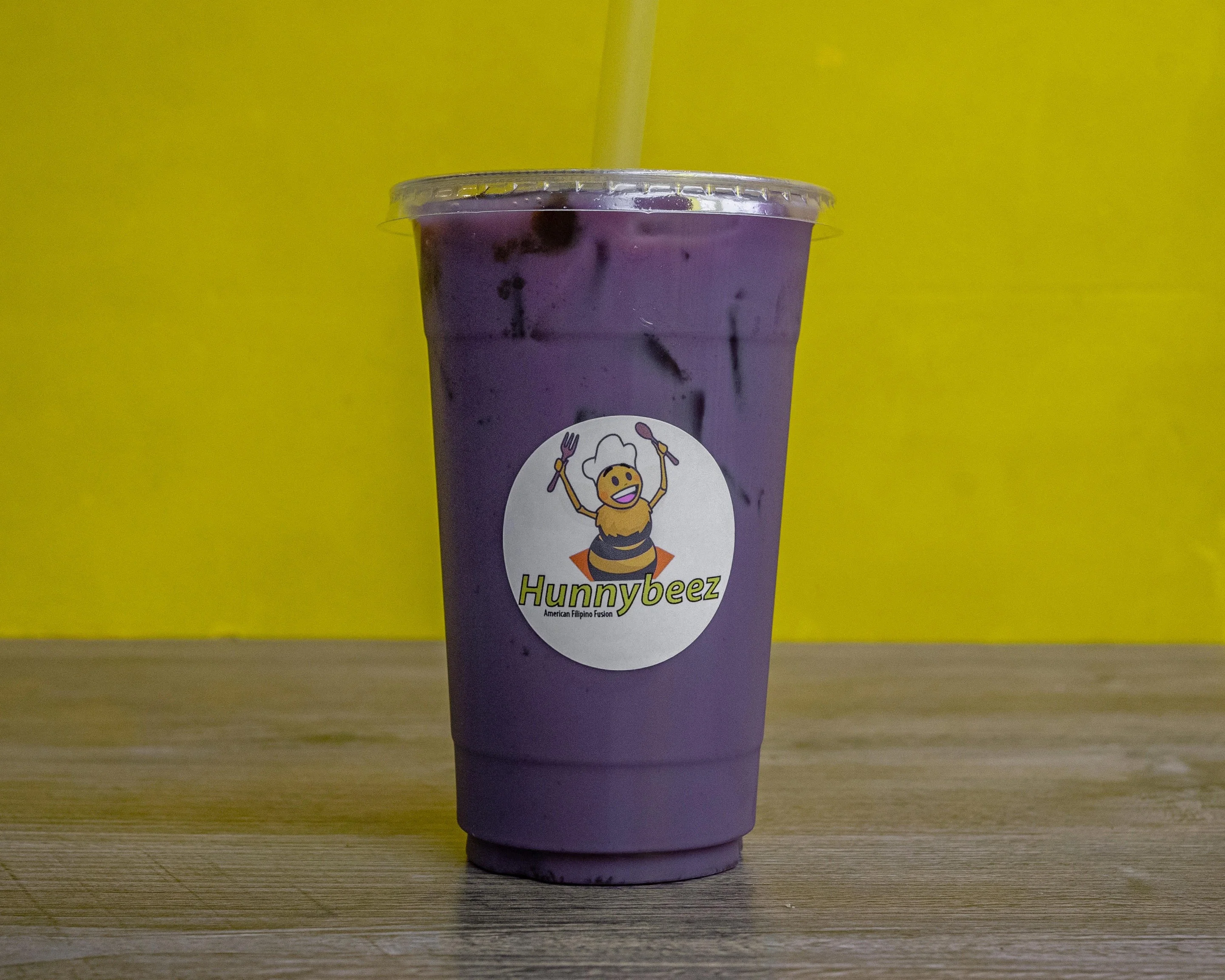 Purple ube drink in a clear cup from Hunnybeez