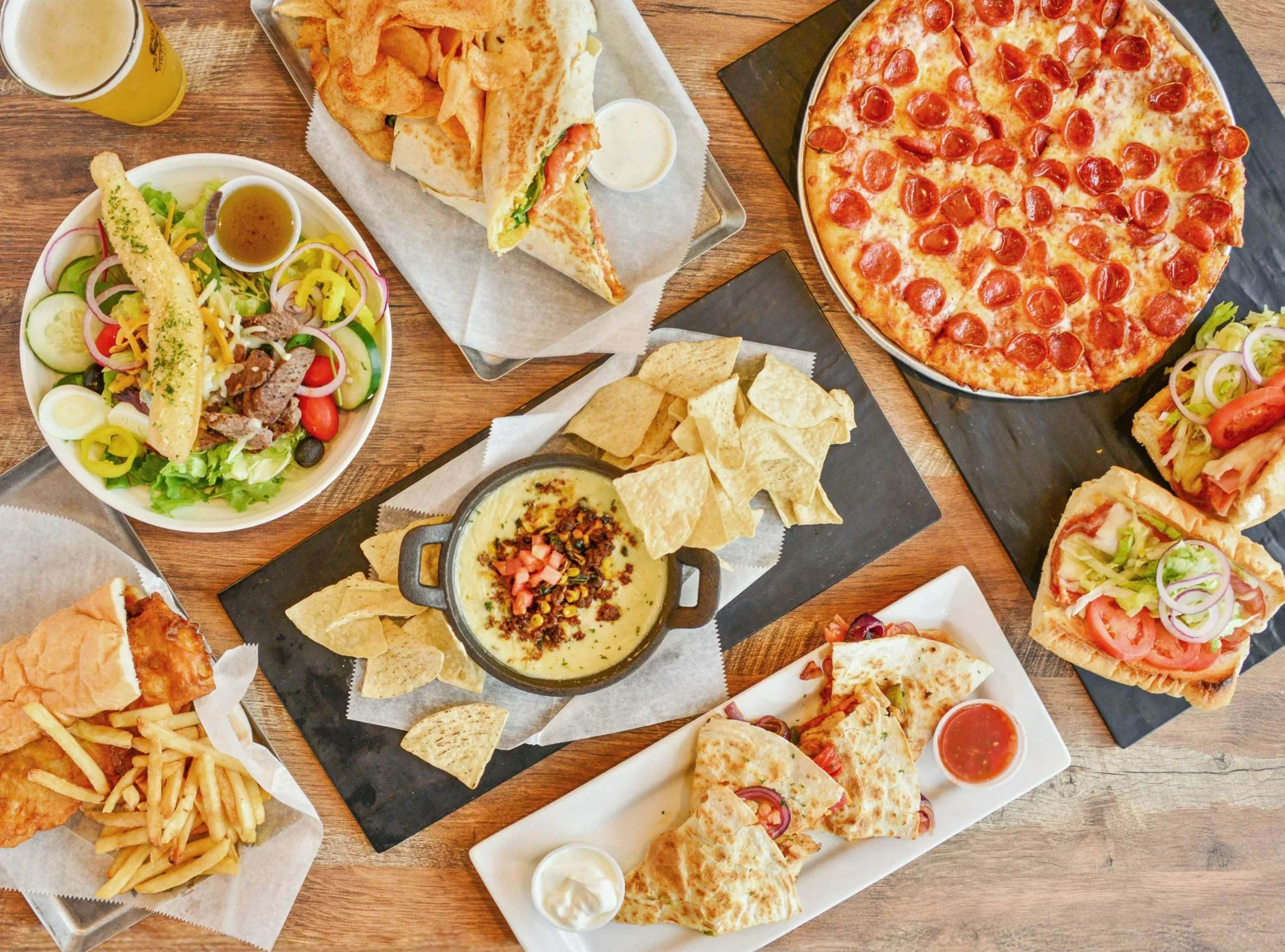 Assorted American pub food including pizza and nachos