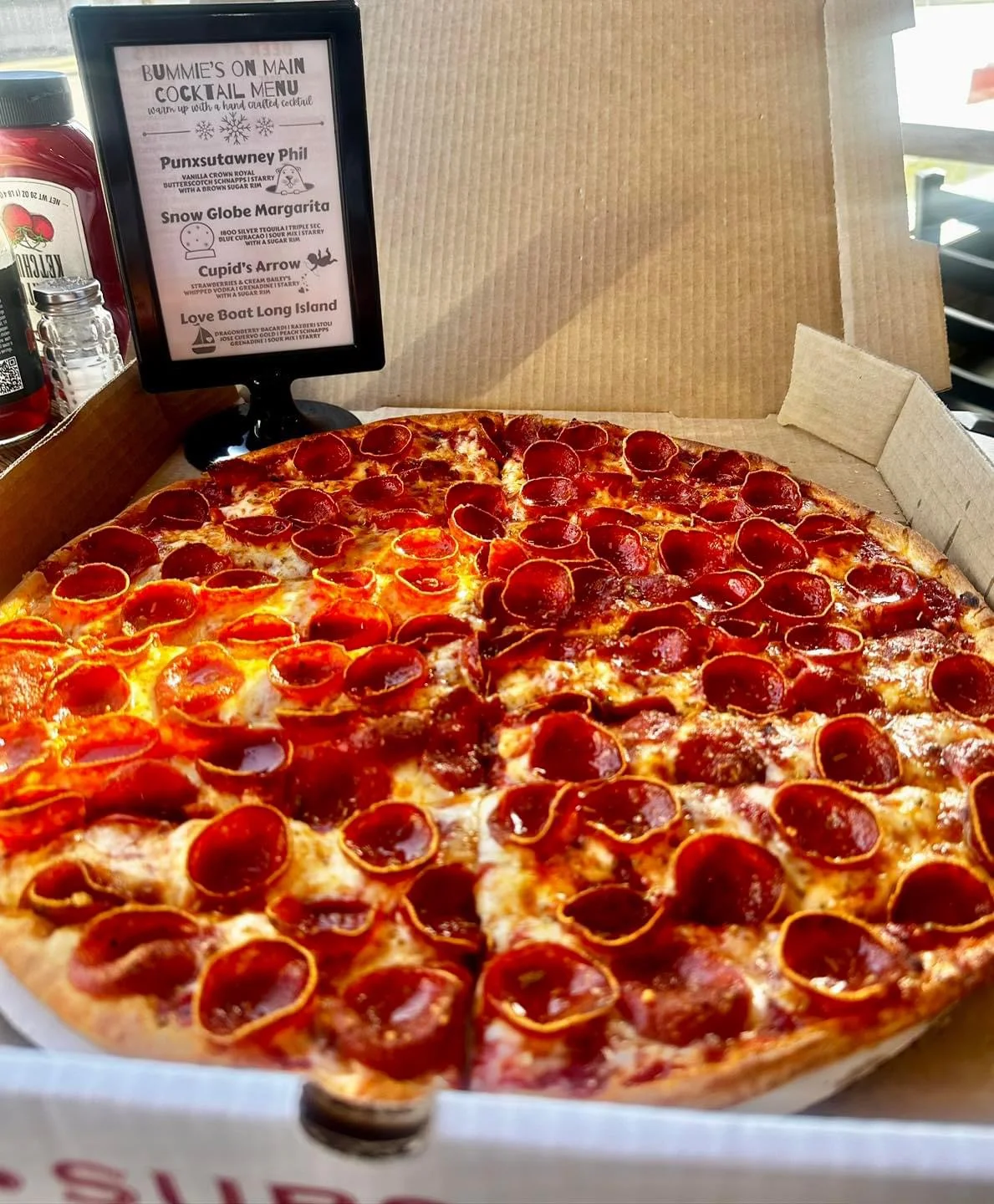 Pepperoni pizza in a takeout box from a local pizzeria