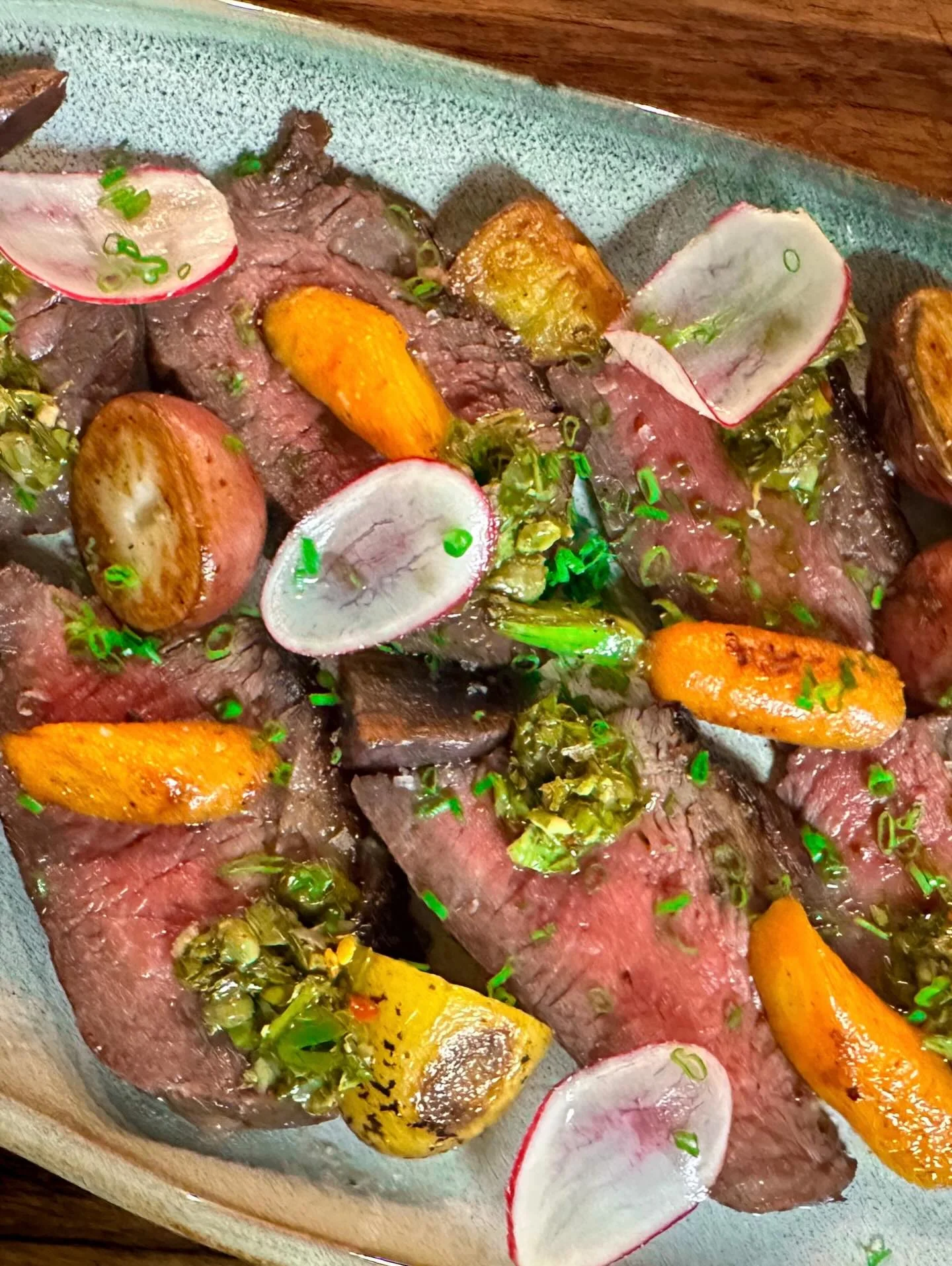 Sliced beef with seasonal vegetables, a modern American dish