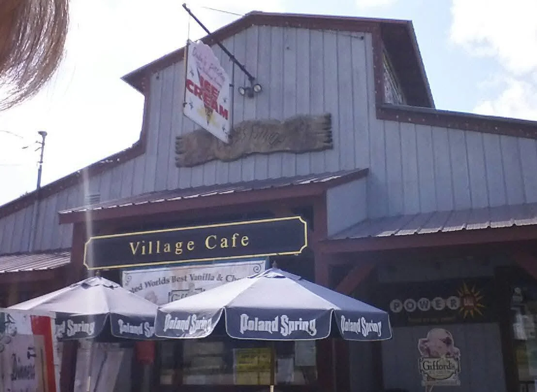 Village Cafe exterior with ice cream sign and outdoor seating