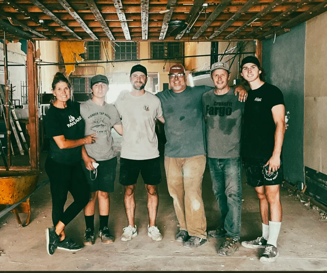 Group of six people in a construction site for a restaurant renovation.