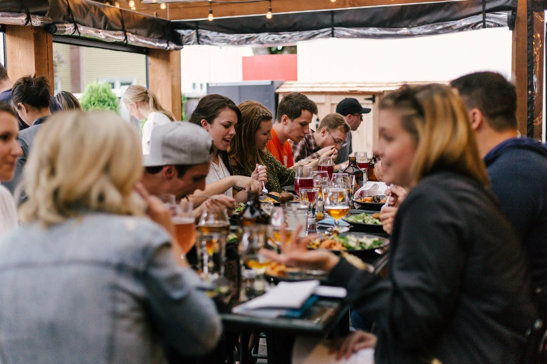 Outdoor dining scene with friends enjoying a meal together
