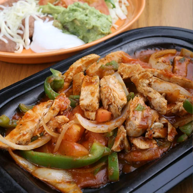 Sizzling chicken fajitas served with fresh toppings