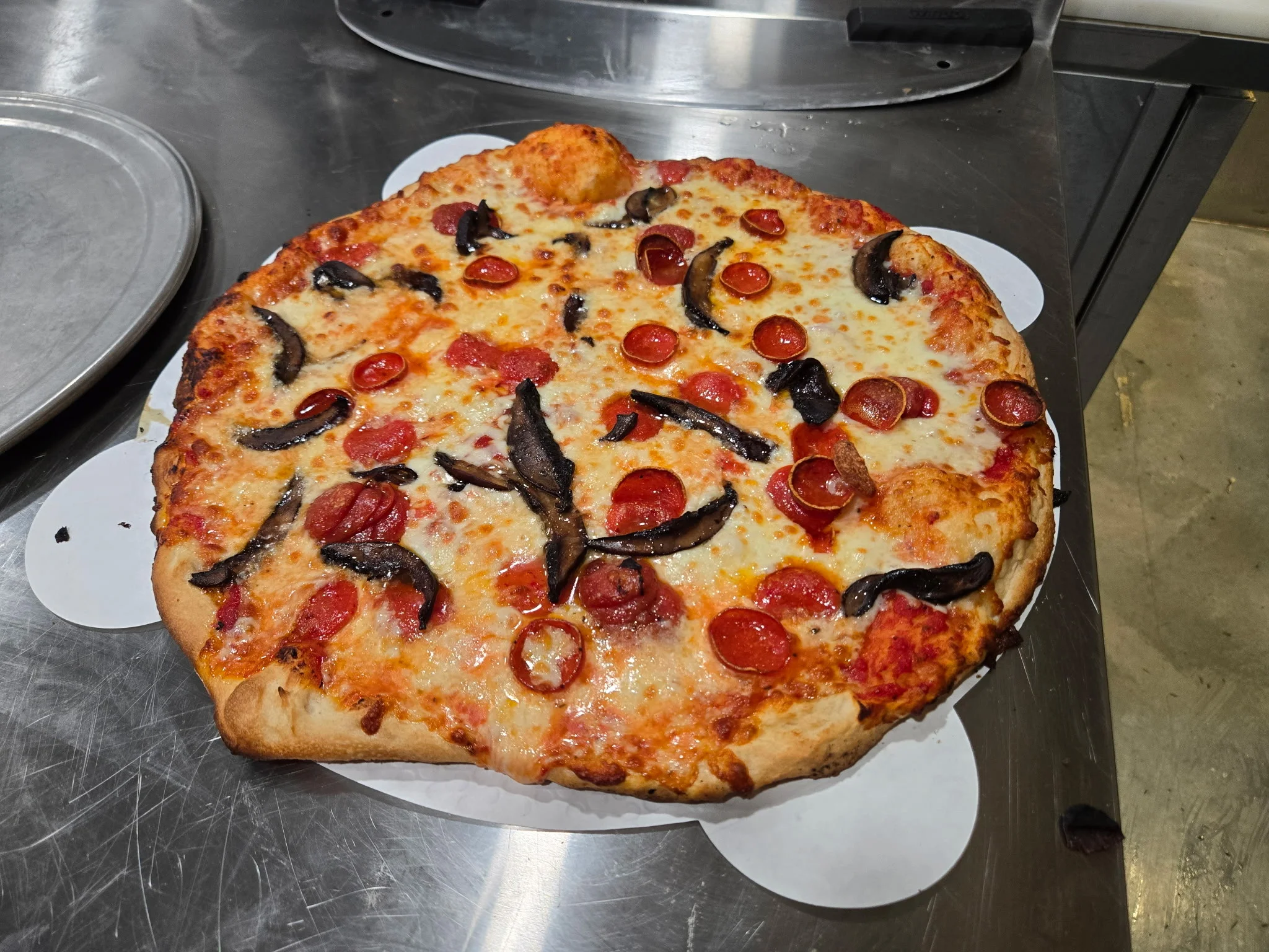 Pepperoni pizza with mushrooms from a pizzeria