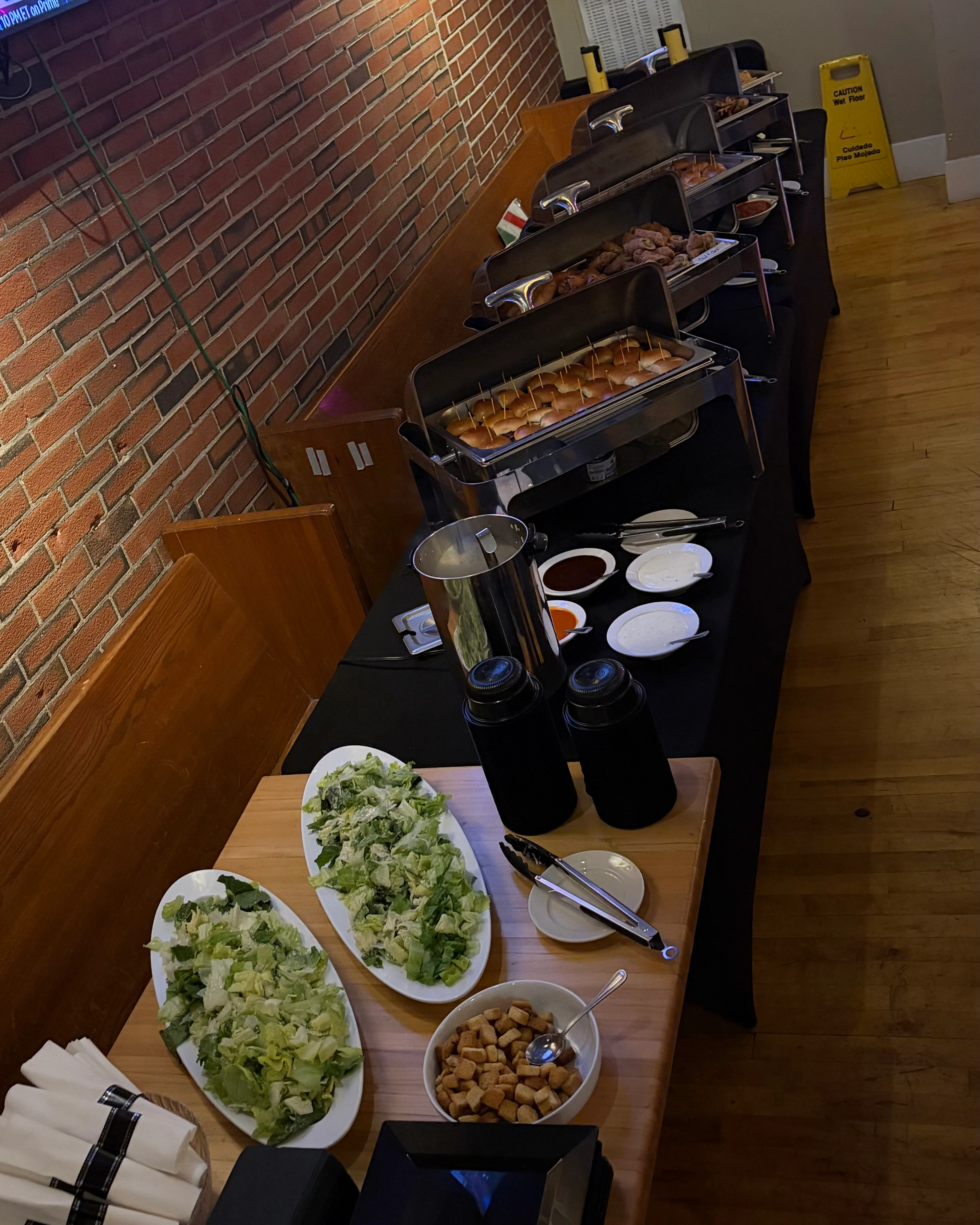 Buffet setup with assorted meats and fresh salads in a cozy restaurant