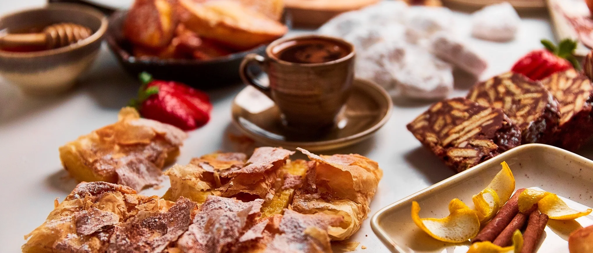 Assorted Middle Eastern pastries with coffee and honey