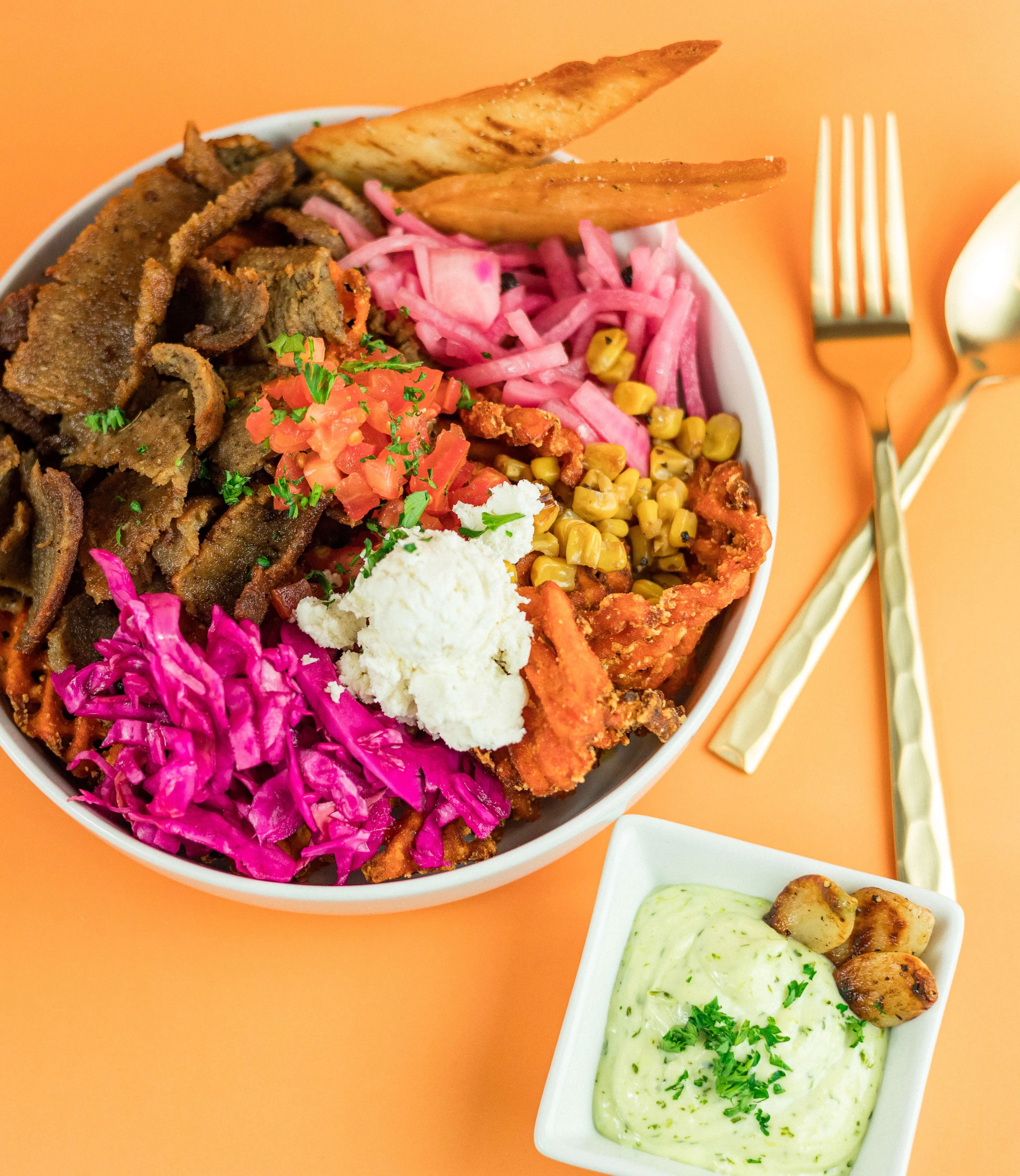 Santorini's Mediterranean rice bowl with gyro meat, pickled red onions, tzatziki, and fresh toppings