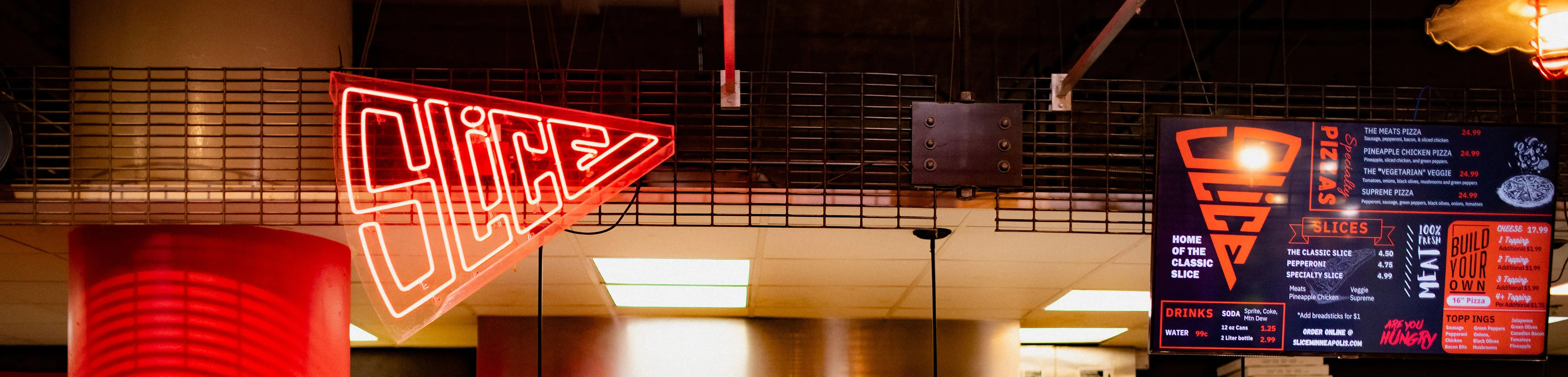 Modern pizza restaurant interior with neon signage