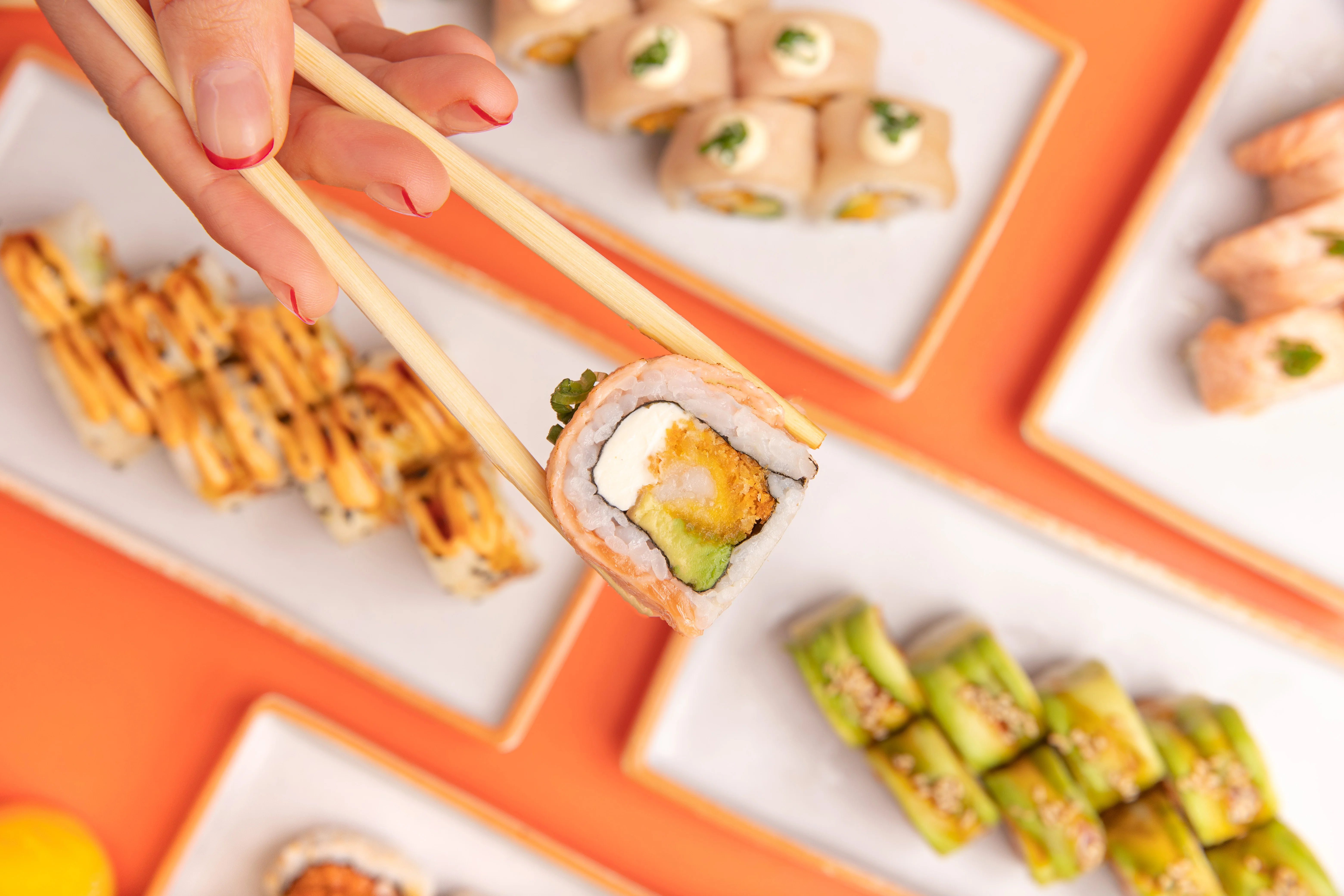 Assorted sushi rolls with chopsticks in a vibrant setting