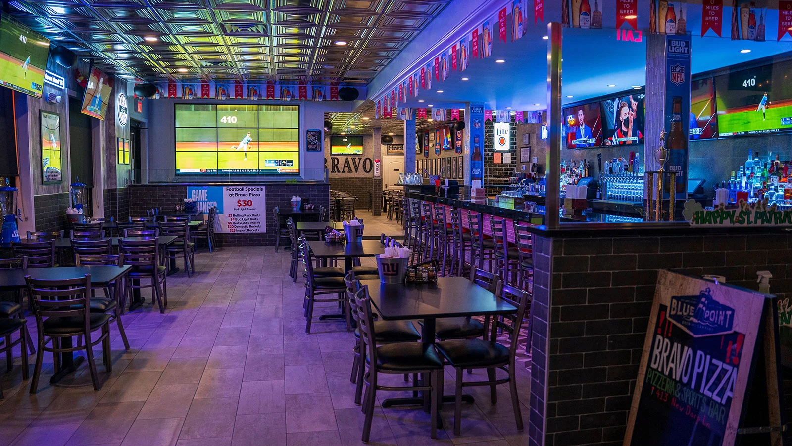 Vibrant sports bar interior with multiple screens and seating