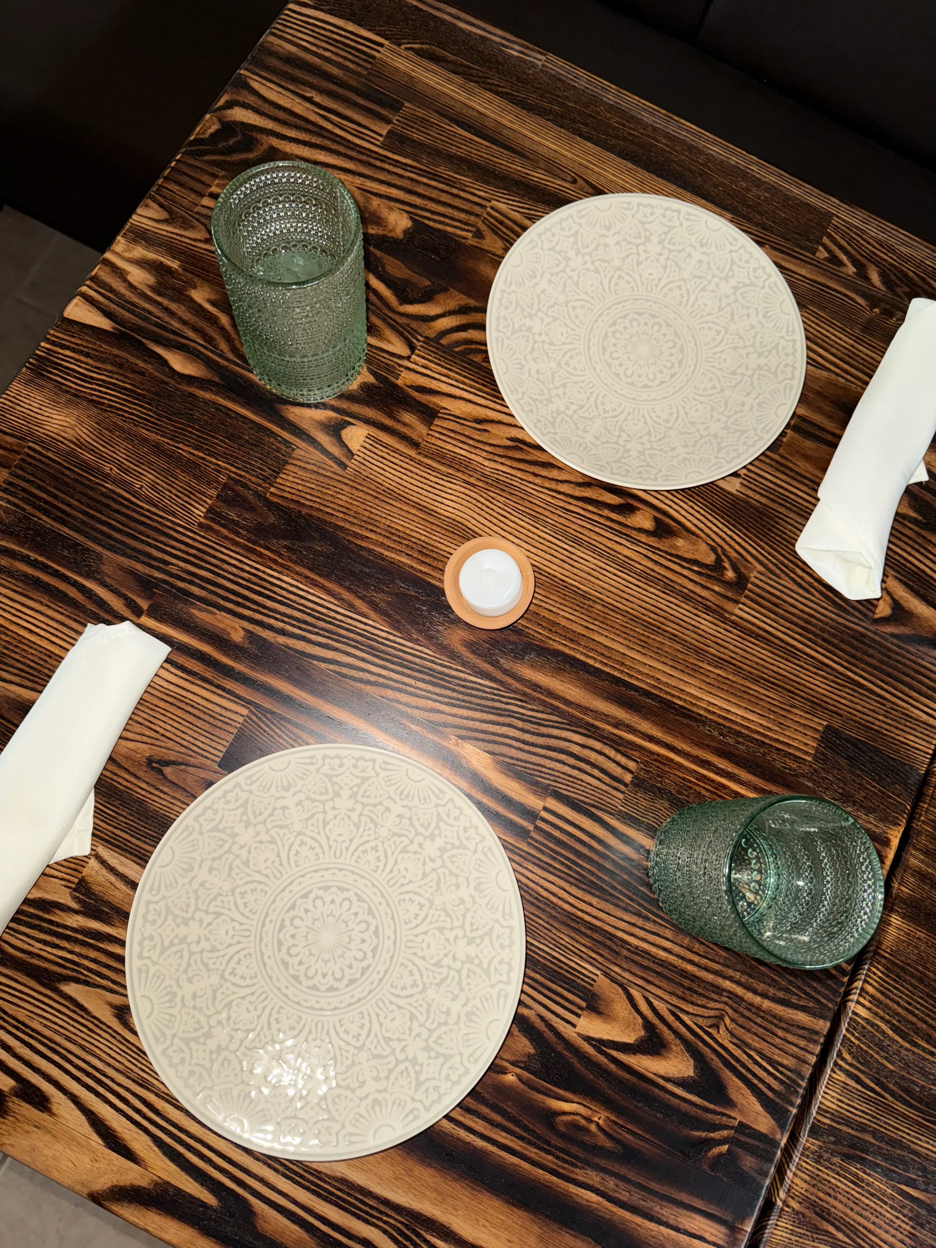 Elegant dining setup with patterned plates and glassware