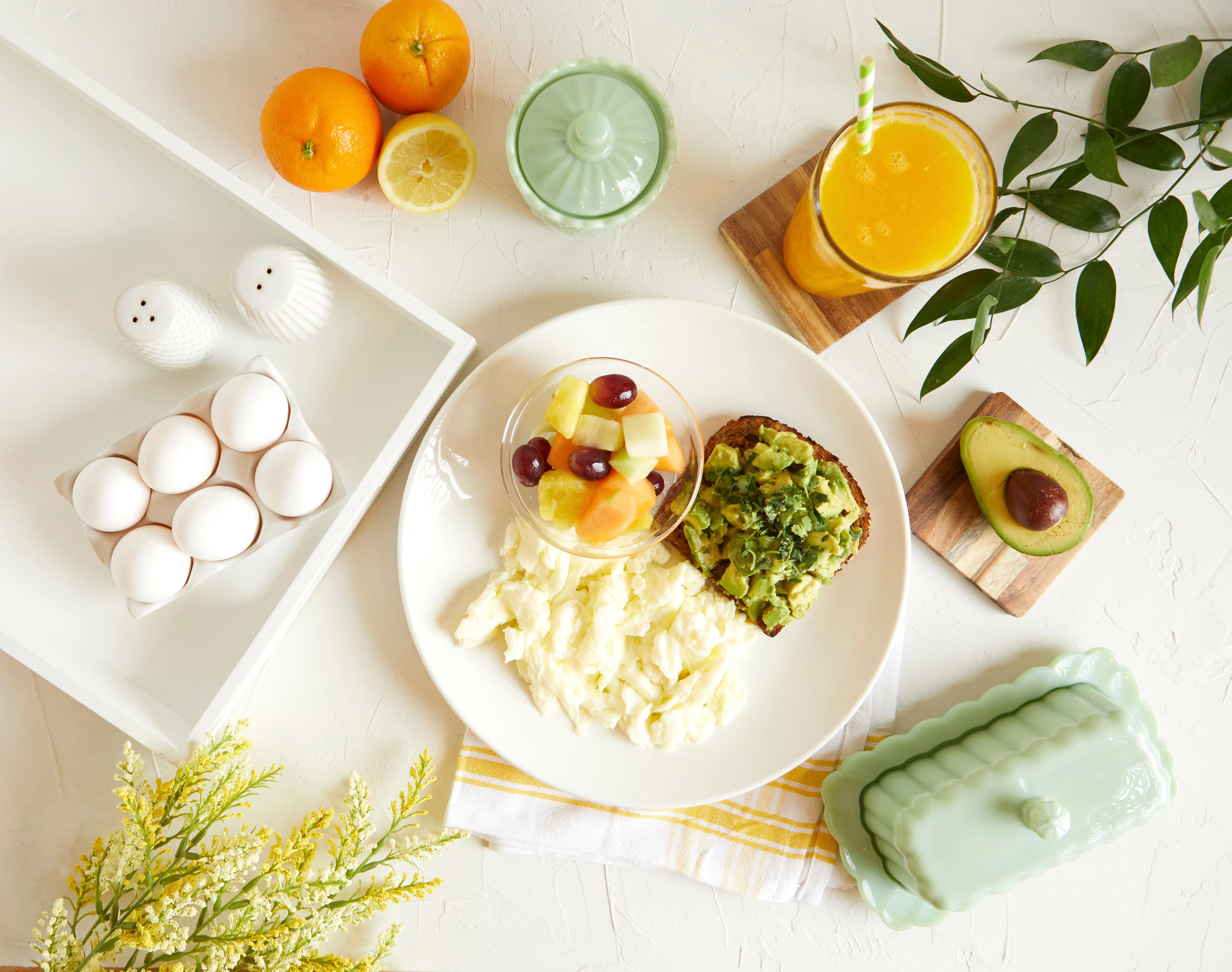 Breakfast plate with avocado toast and fresh fruit salad