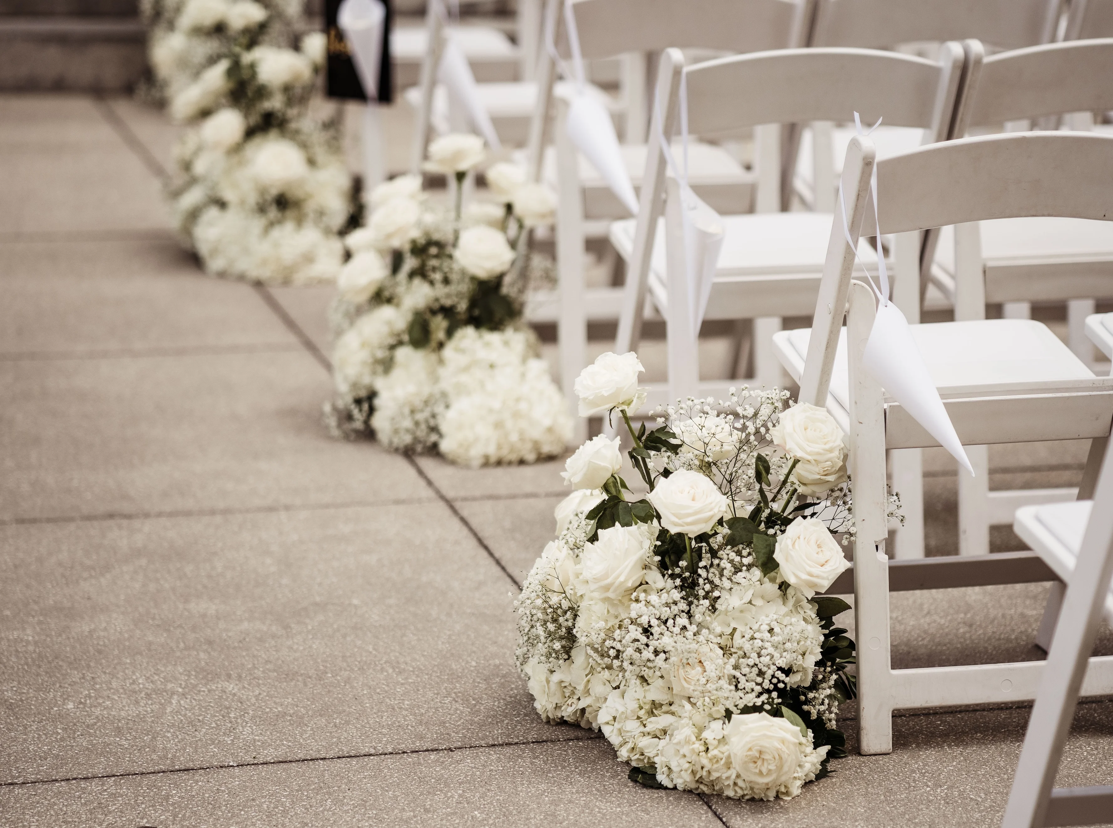 Elegant wedding ceremony setup with white floral arrangements