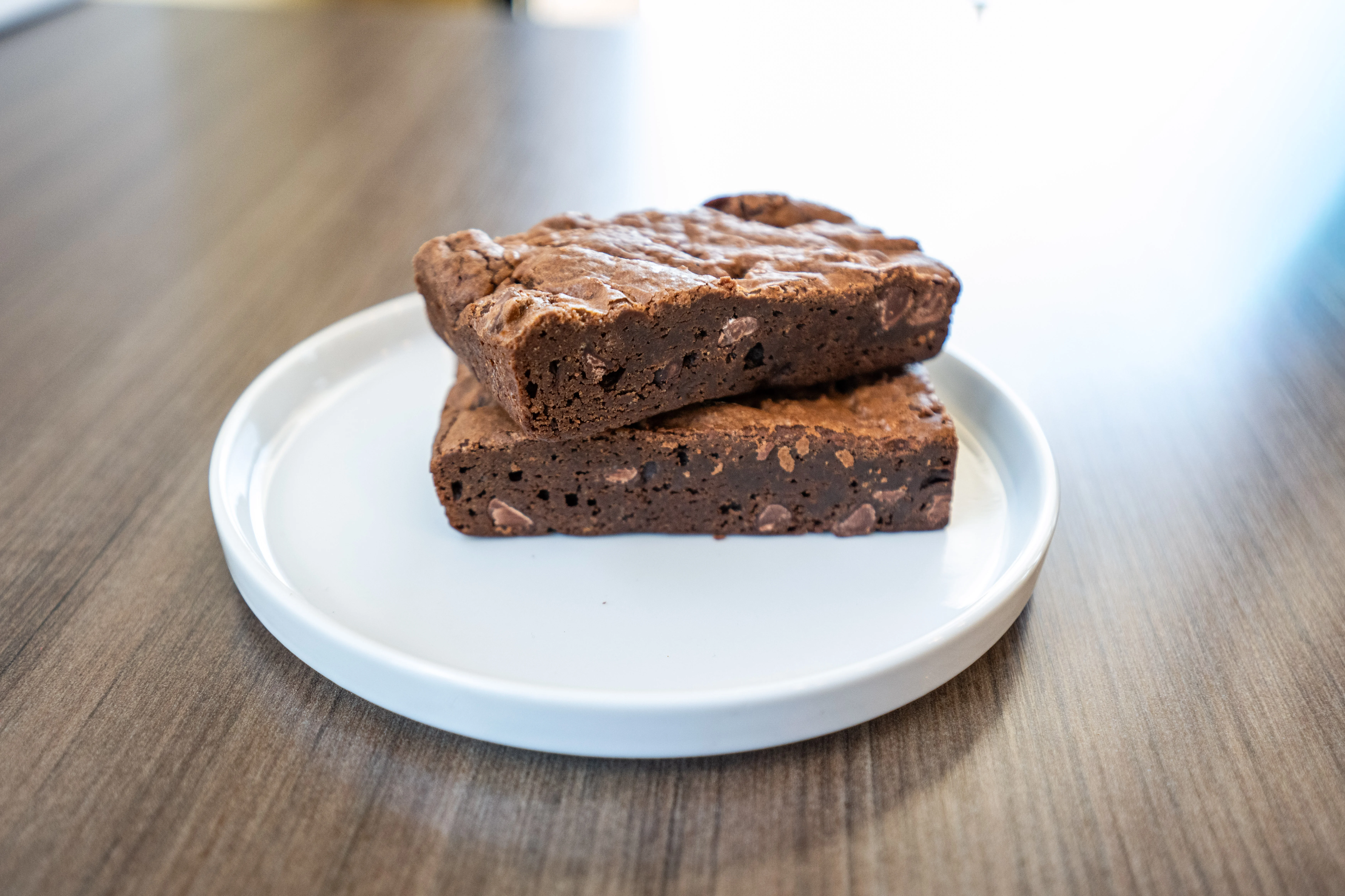 Decadent chocolate brownies on a black plate