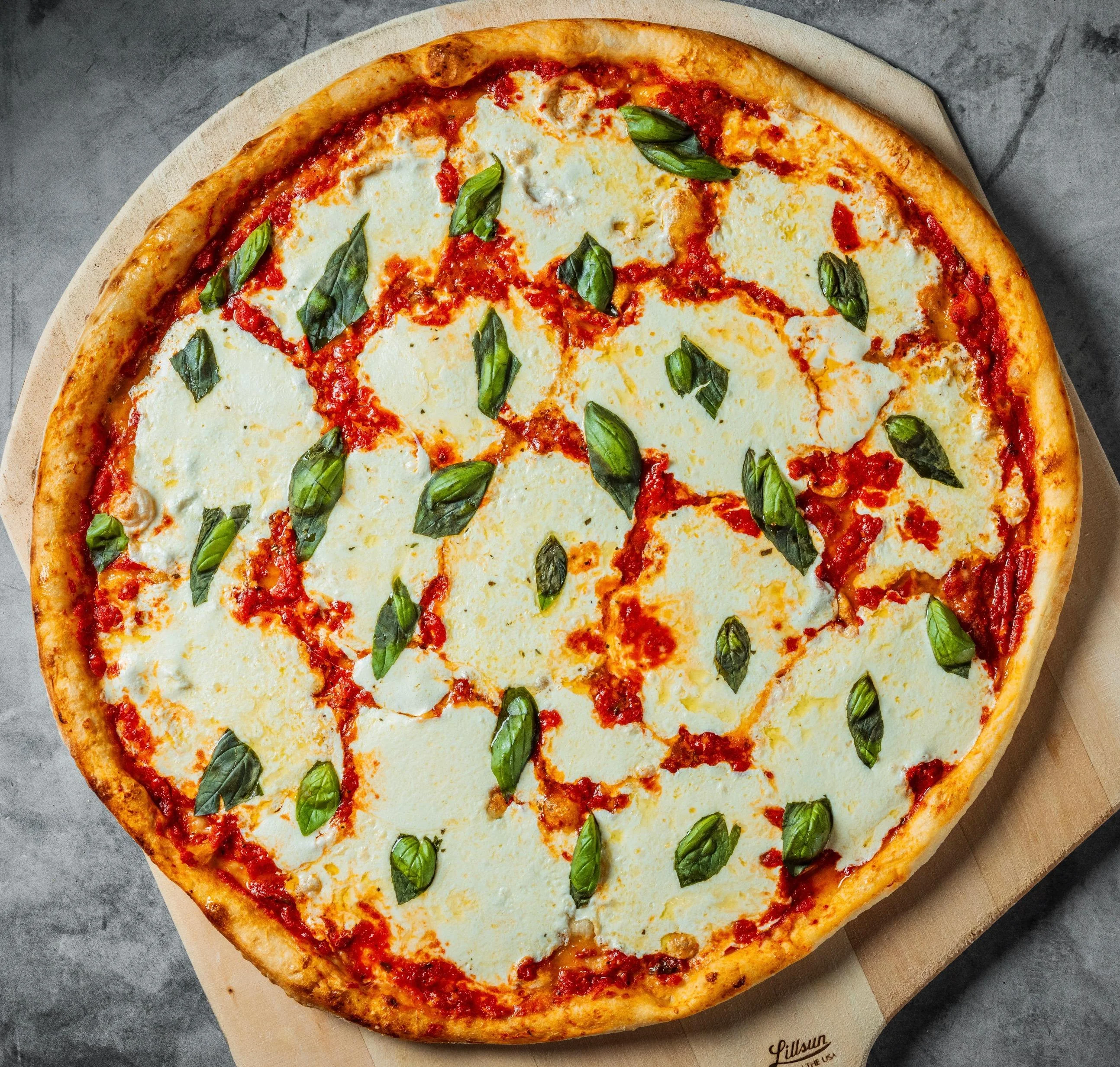 Margherita pizza with fresh mozzarella and basil at Tommy's Pizza