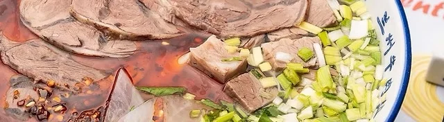 Spicy Sichuan beef noodle soup with fresh herbs and chili oil