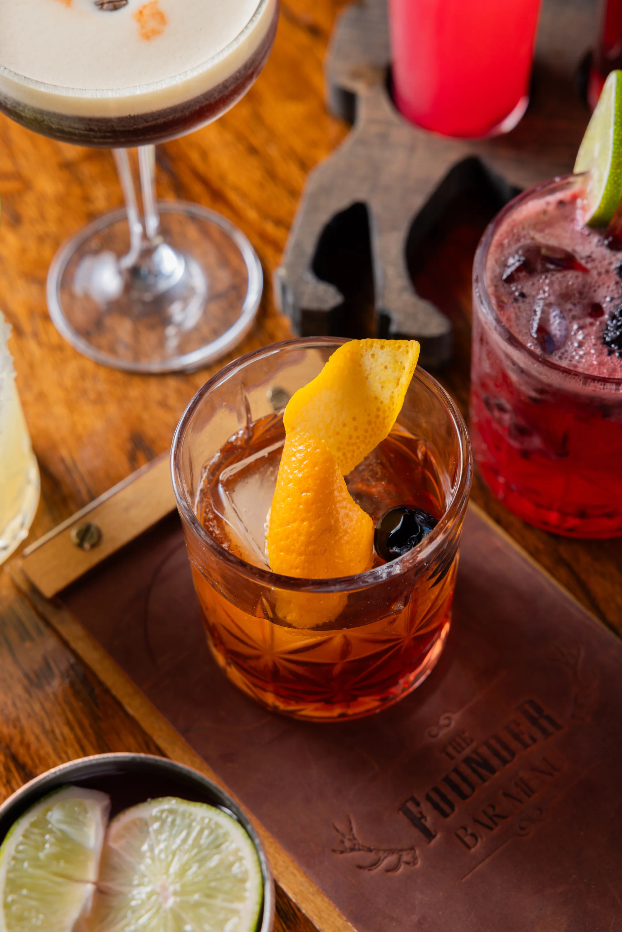 Classic Old Fashioned cocktail with orange twist and cherry garnish