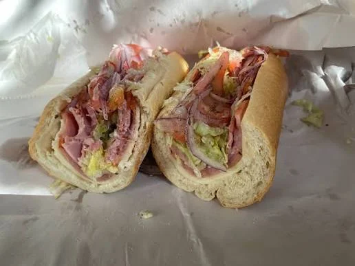 Italian sub sandwich with layers of meats and fresh vegetables