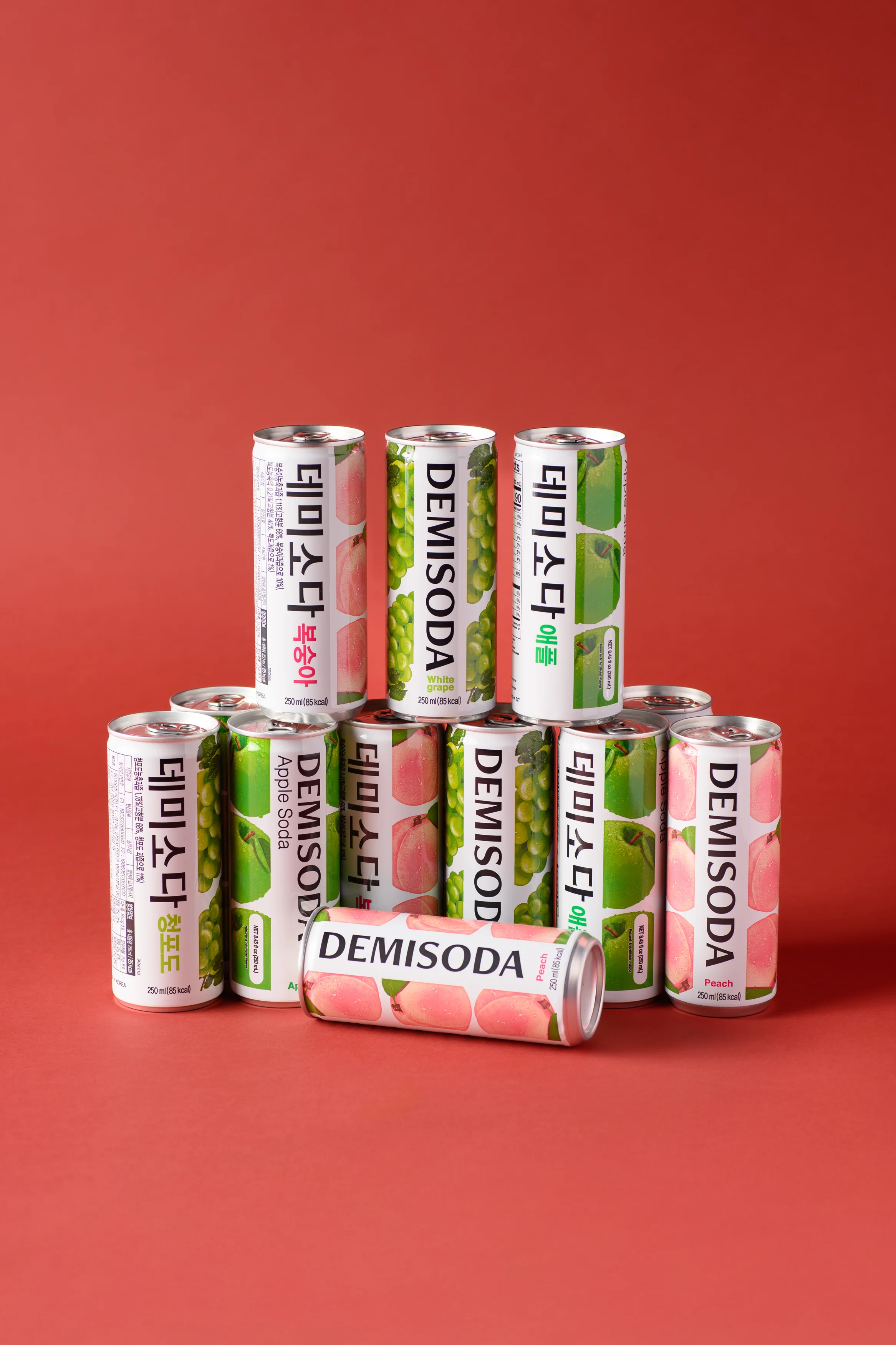 Variety of Demisoda flavored soft drinks on a red background