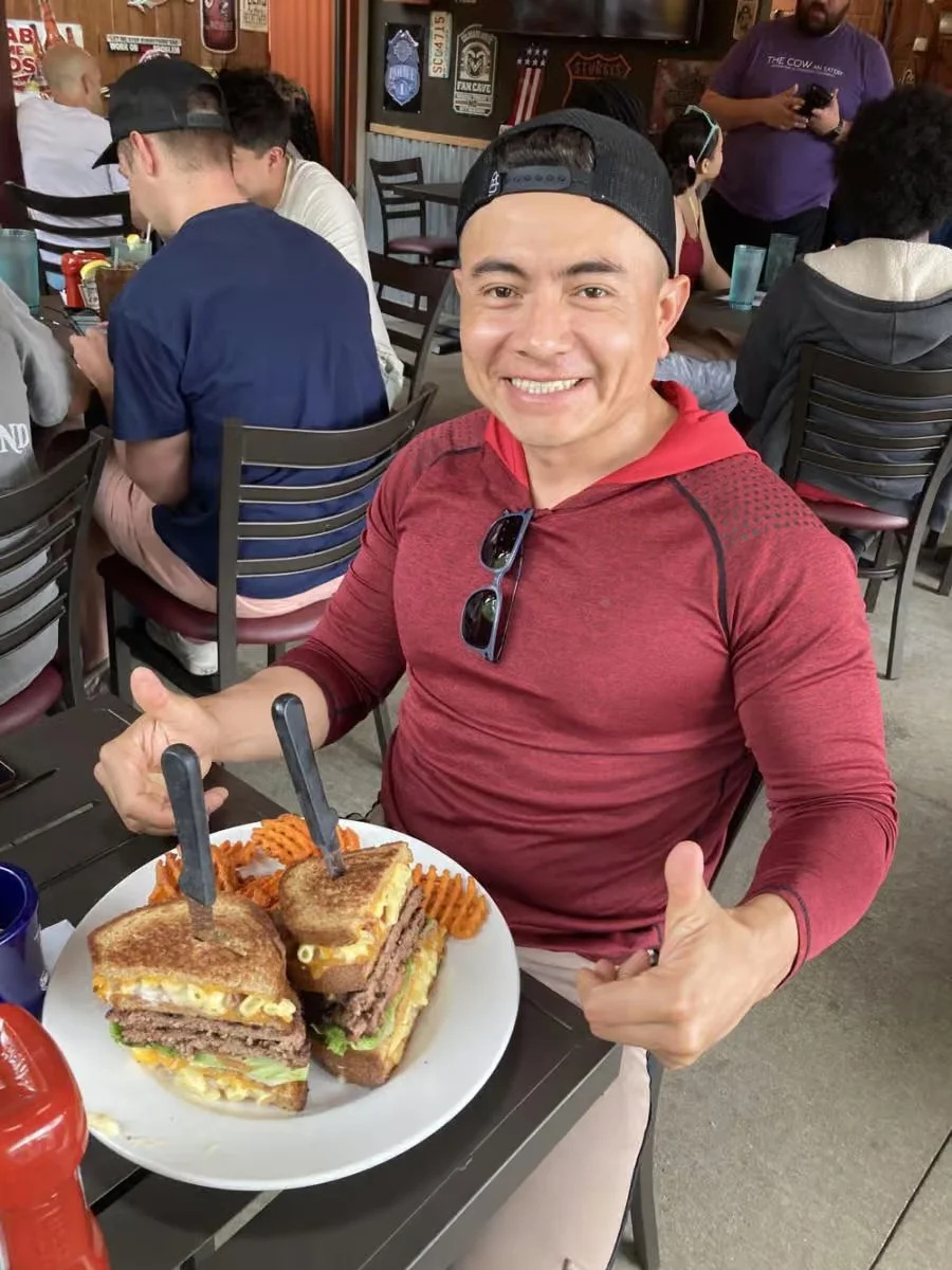 Giant stacked cheeseburger sandwich with sweet potato fries