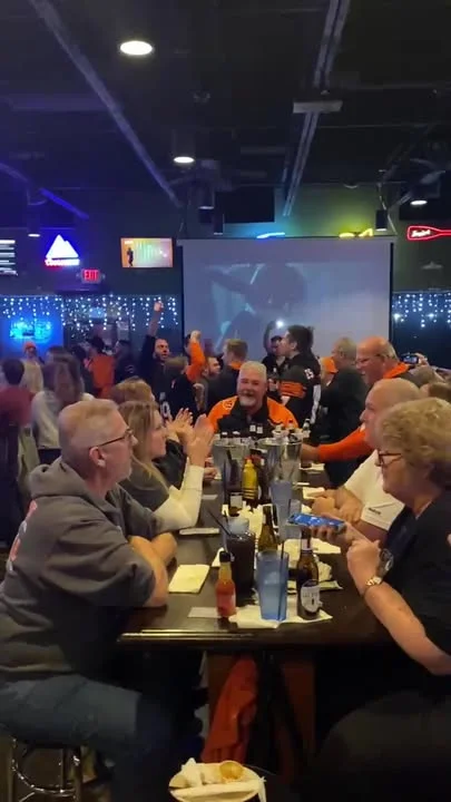 Lively sports bar scene with fans celebrating a game night