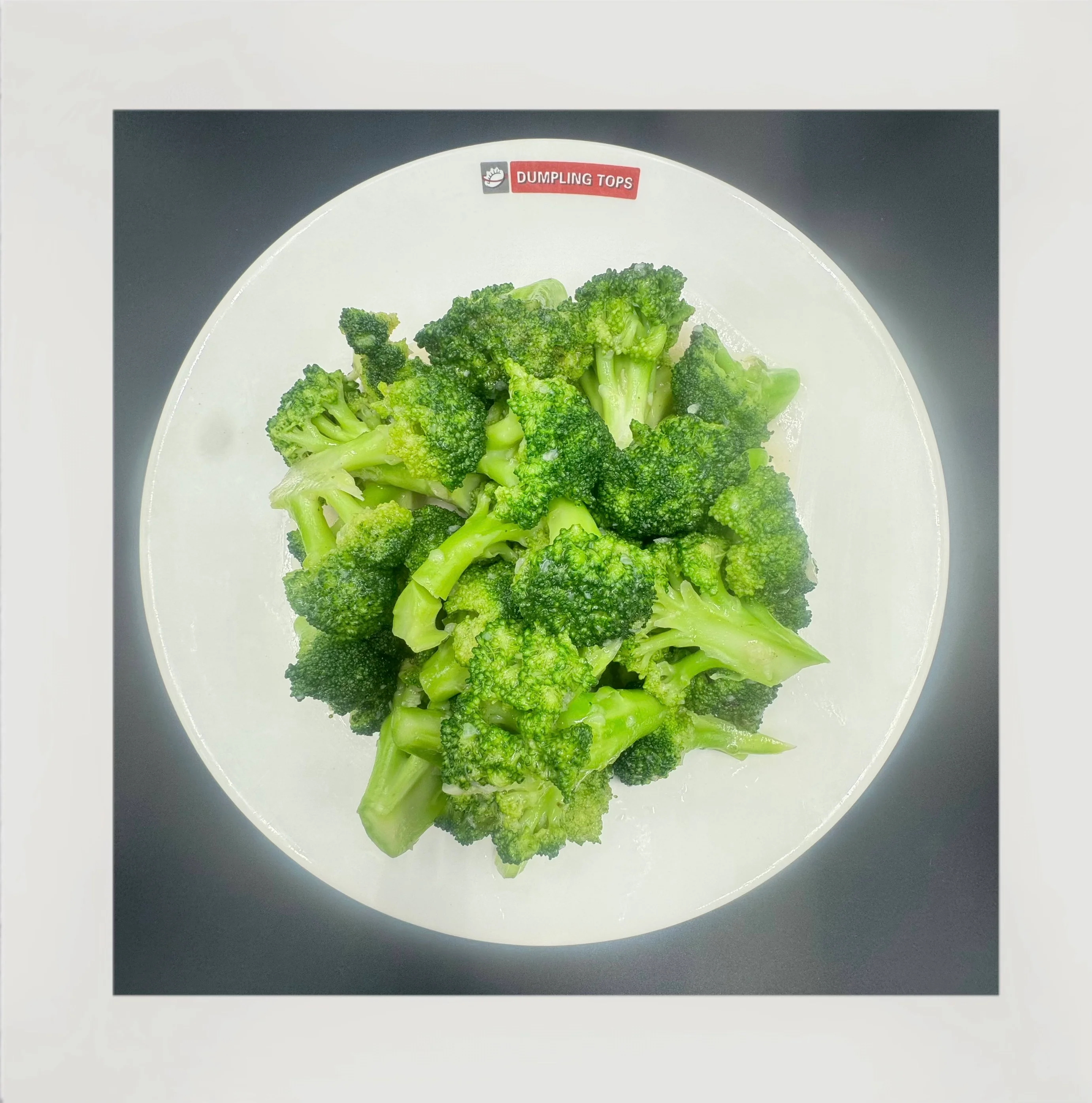 Fresh steamed broccoli served in a white bowl