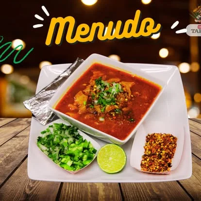 Authentic Mexican menudo served with lime and fresh herbs